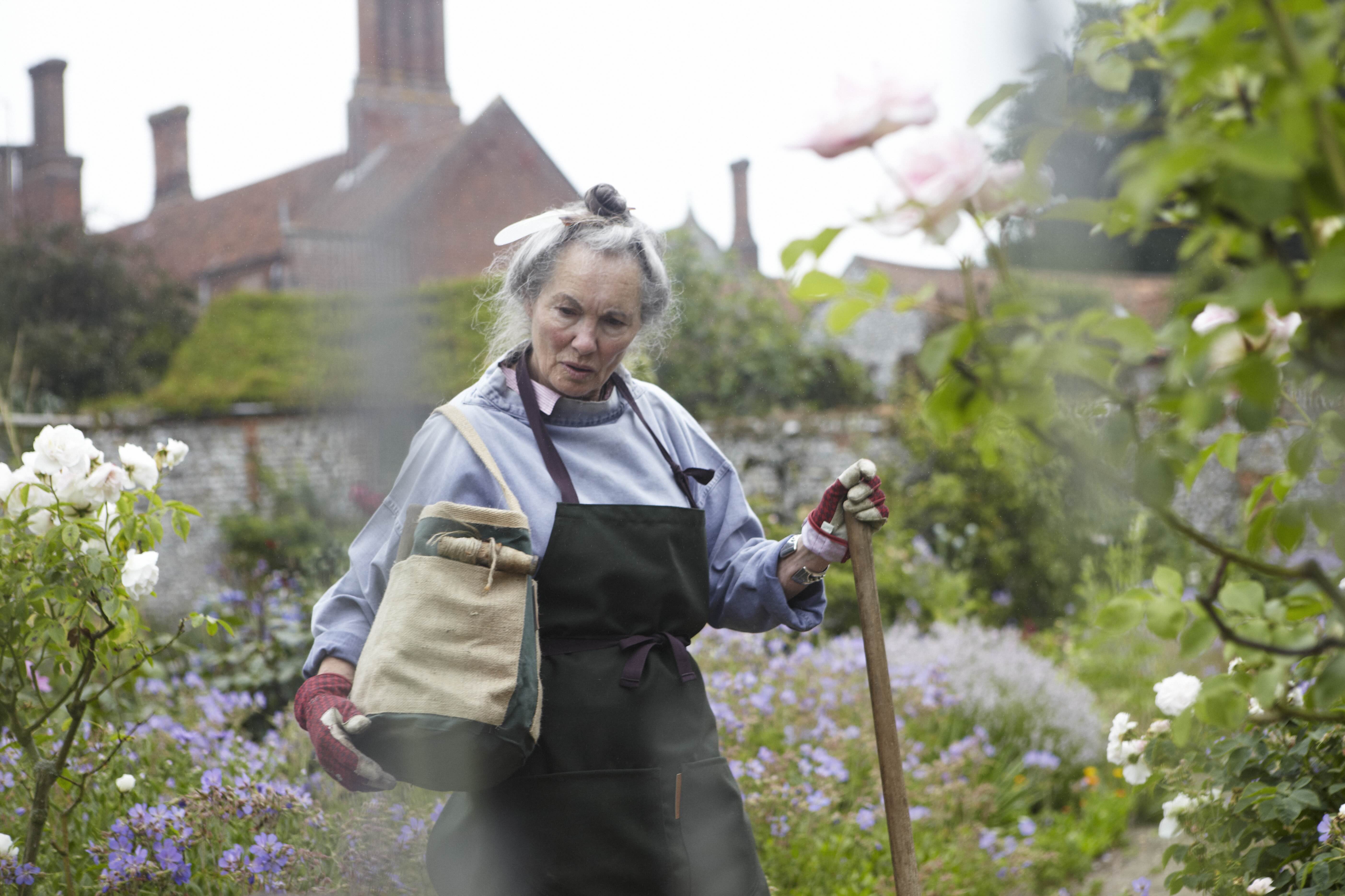 Man standing in field of corn wearing Carrier Company Work jacket in Navy Cotton Drill