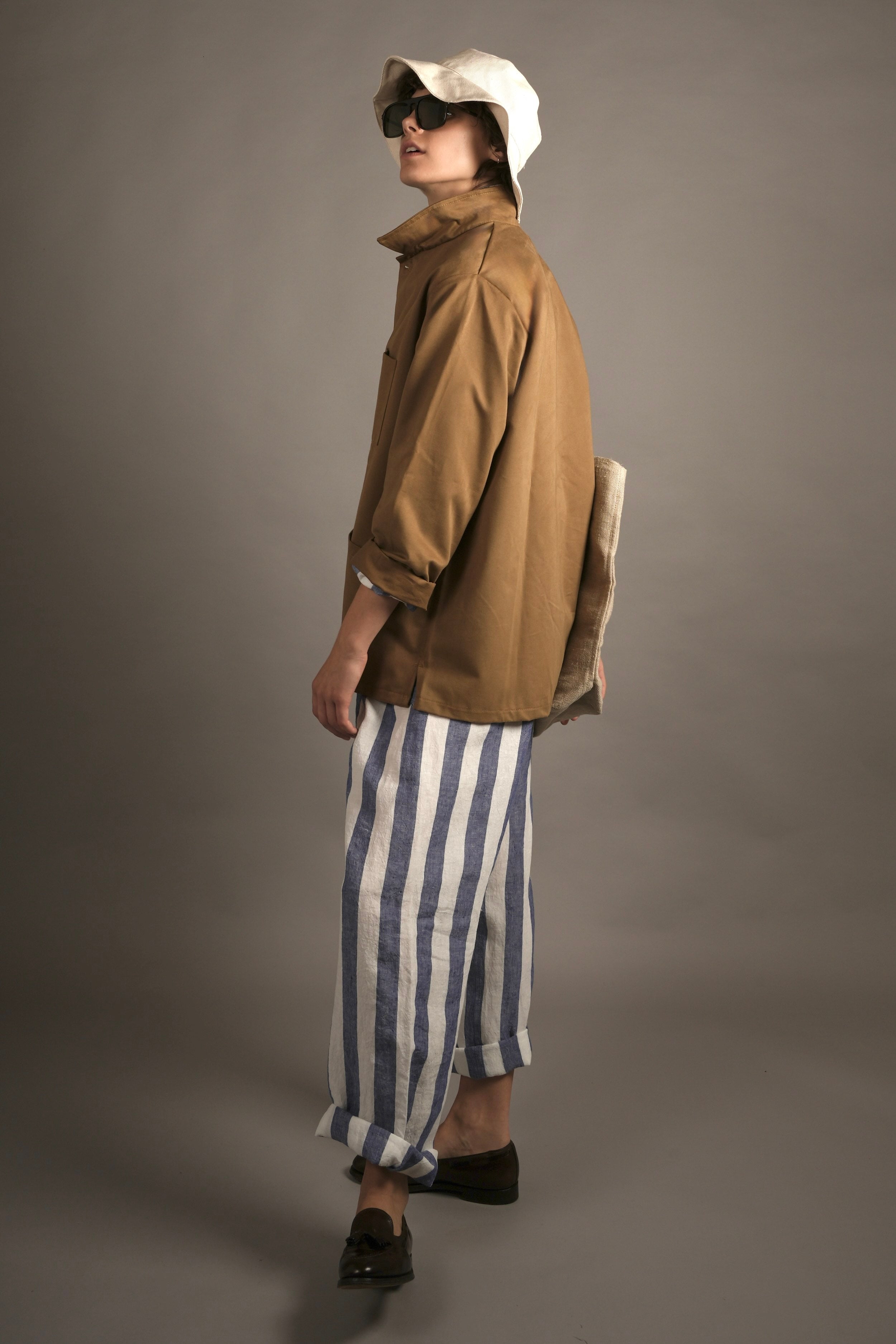 Els Wears Carrier Company Blue & White Striped Linen Pyjamas, Cotton Sun Hat and Norfolk work Jacket in Tan