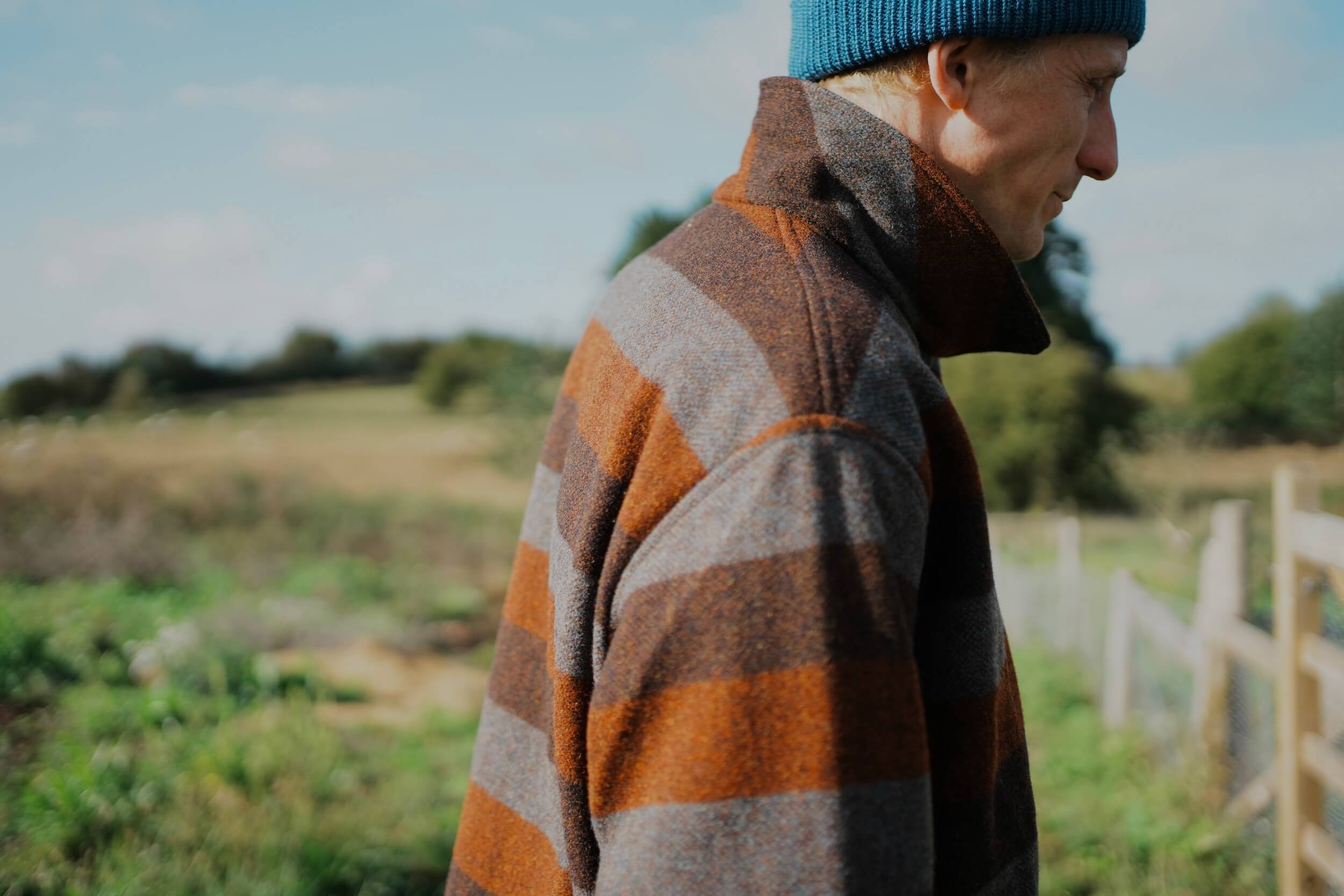 Tommy Wears Carrier Company Yorkshire Wool Jacket In Conker Stripe WIth Merino Wool Jumper, Wool Watch Cap & Men's Work Trouser in Tan