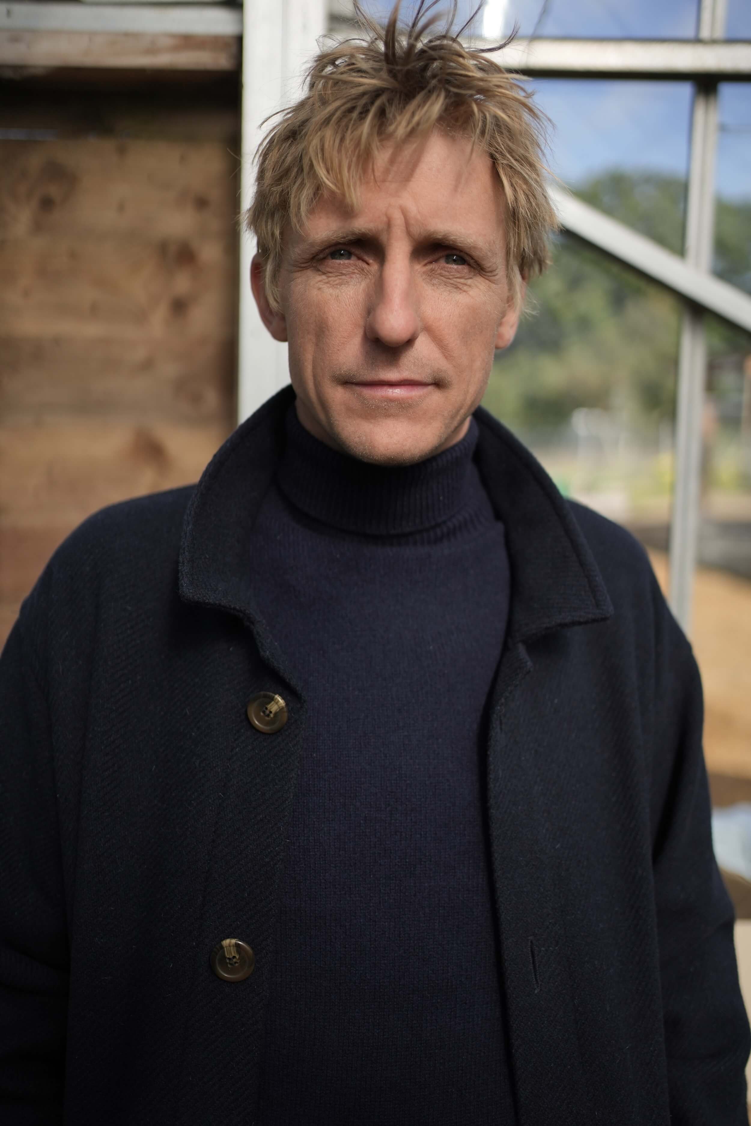 Tommy Wears Carrier Company Plain Wool Jacket in Navy, Supersoft Merino Rool Neck Jumper and Men's Work Trousers In Tan