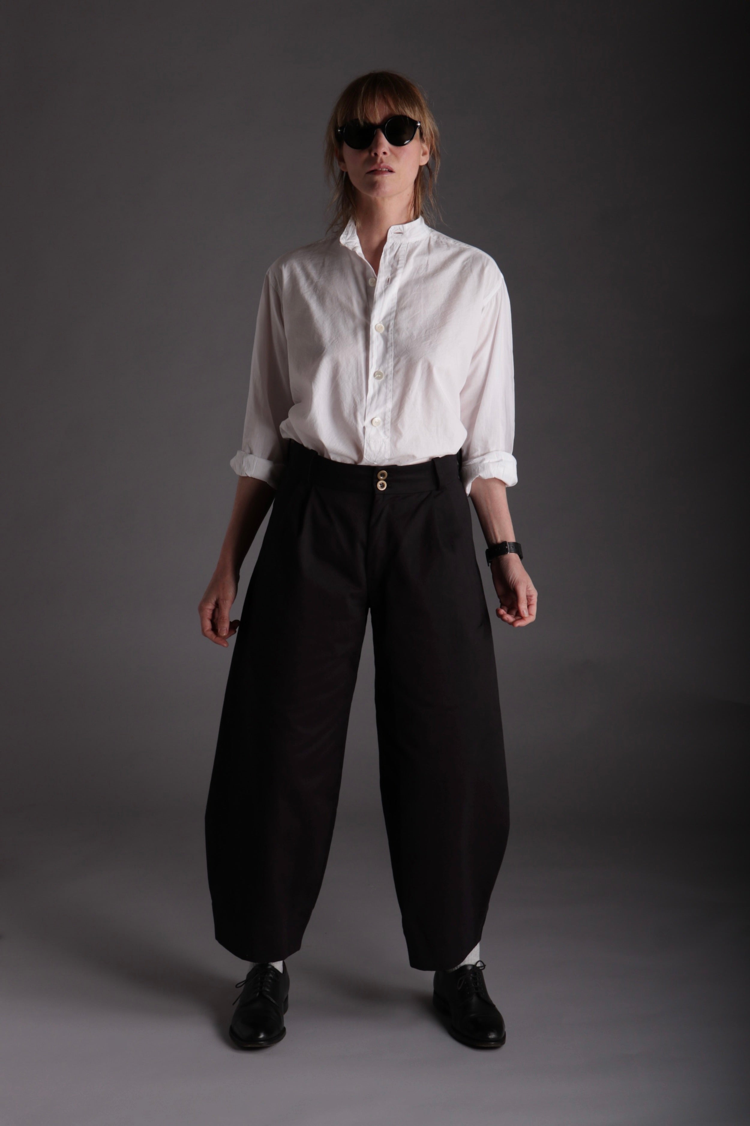 Sienna wears Carrier Company Dutch Trousers in Black Cotton Drill with Lightweight Collarless Shirt