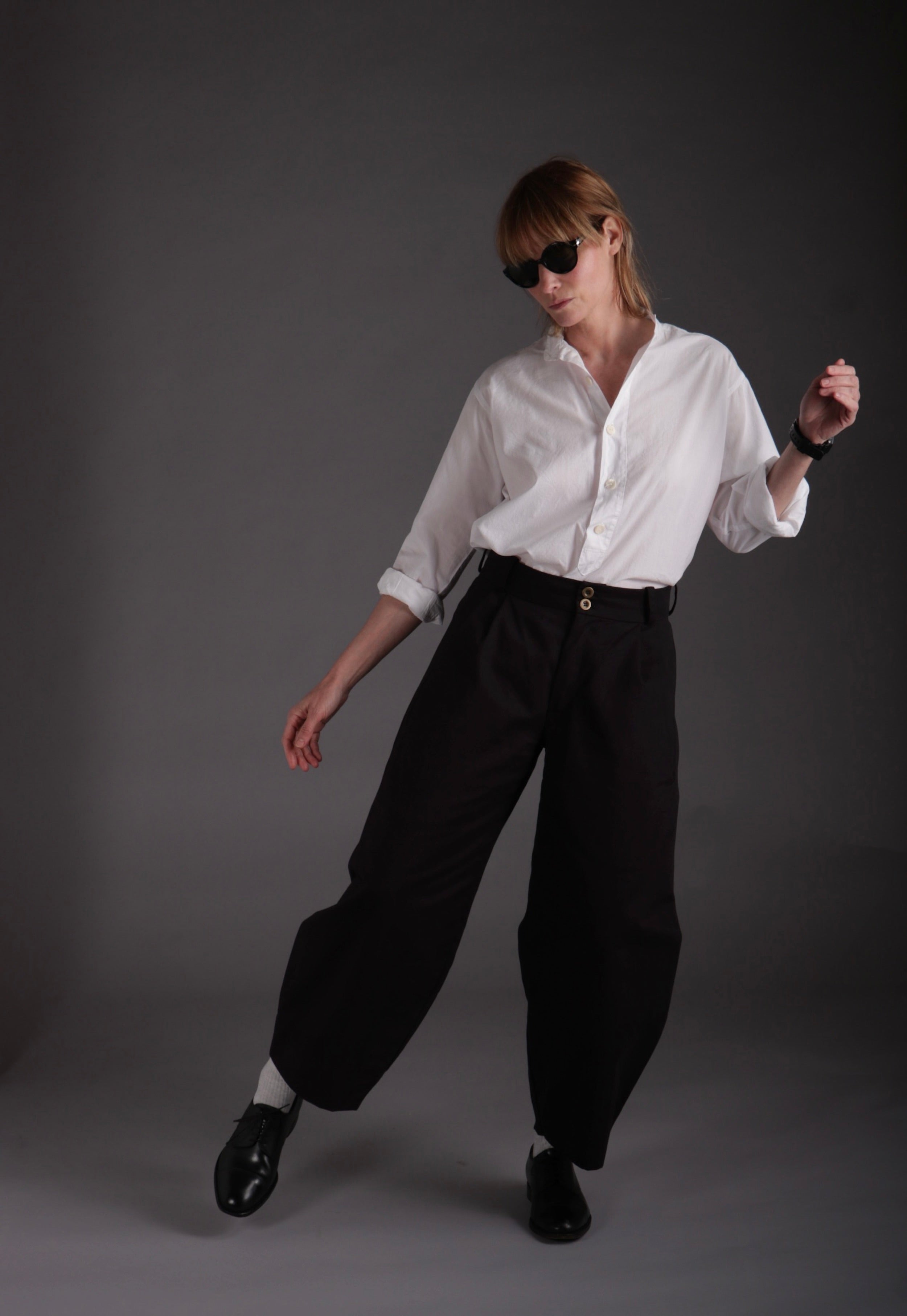 Sienna wears Carrier Company Dutch Trousers in Black Cotton Drill with Lightweight Collarless Shirt