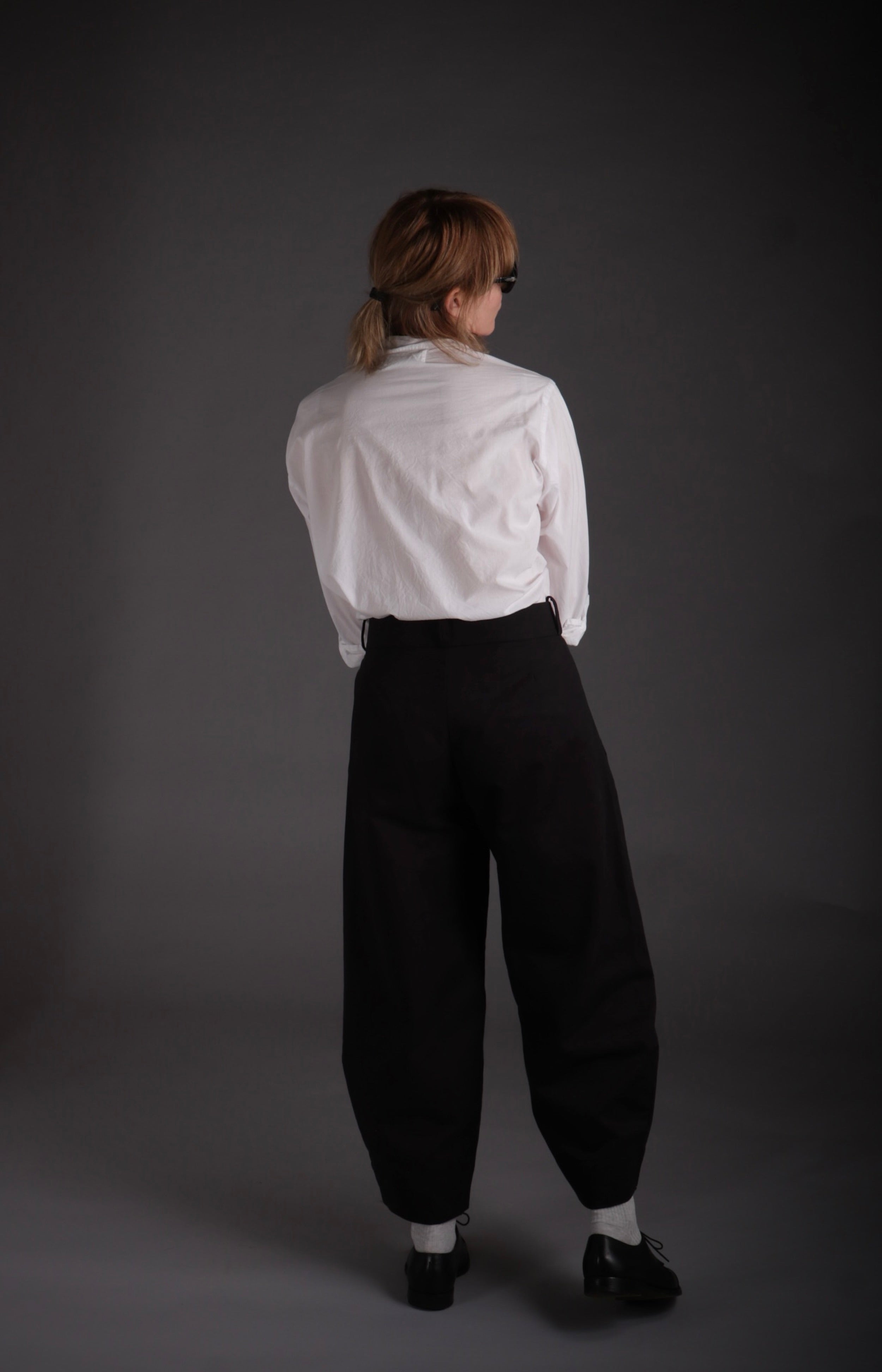 Sienna wears Carrier Company Dutch Trousers in Black Cotton Drill with Lightweight Collarless Shirt