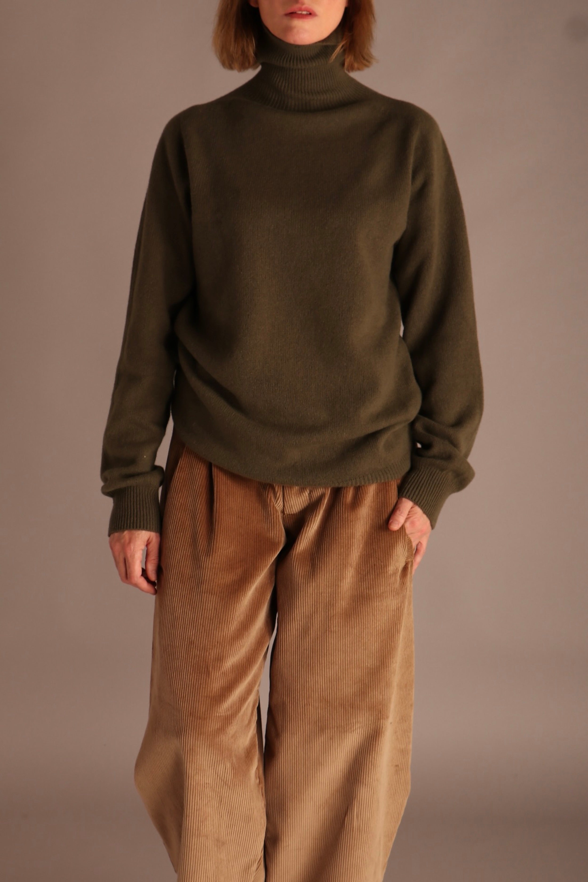 Sienna wears Carrier Company Merino & Cashmere Supersoft Roll Neck Jumper and Dutch Trousers in Corduroy