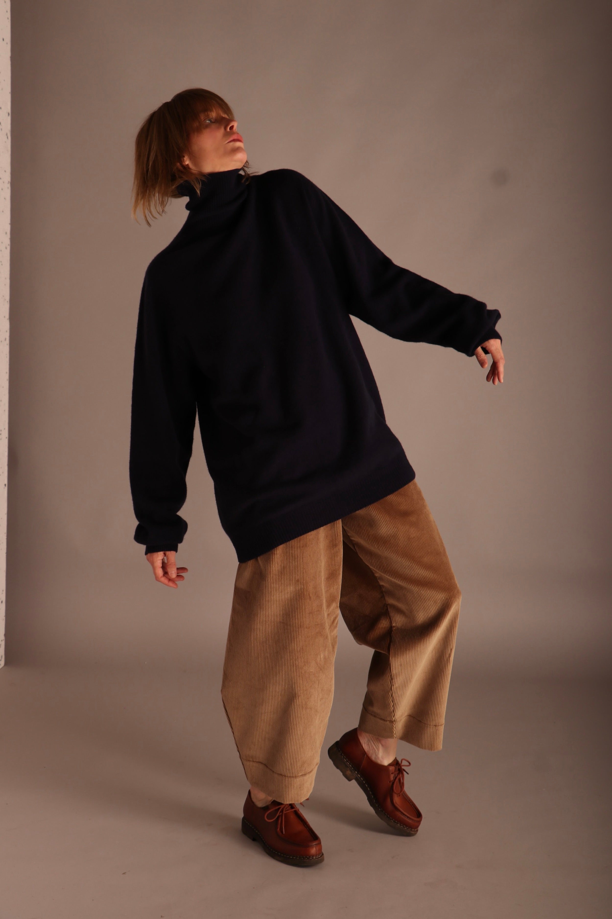 Sienna wears Carrier Company Merino & Cashmere Supersoft Roll Neck Jumper and Dutch Trousers in Corduroy