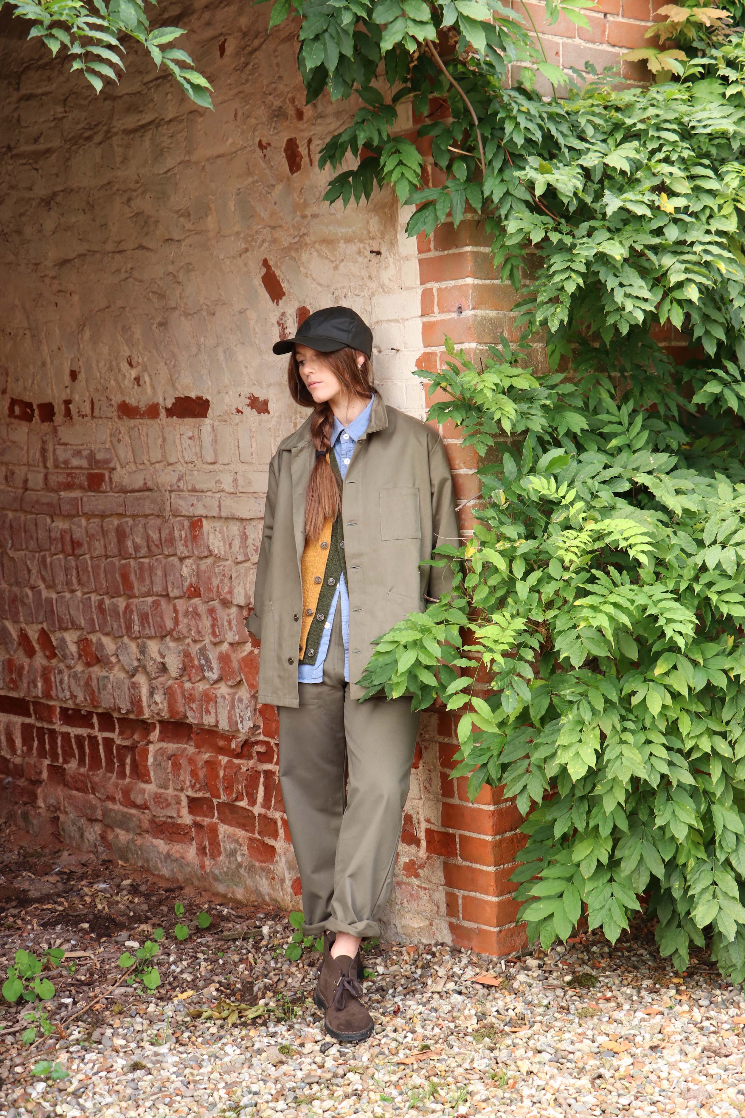 ecca wears Carrier Company Norfolk Work jacket with Sleeveless Cardigans, Pinpoint Chambray Shirt, Oilskin Cap and Women's Work Trouser