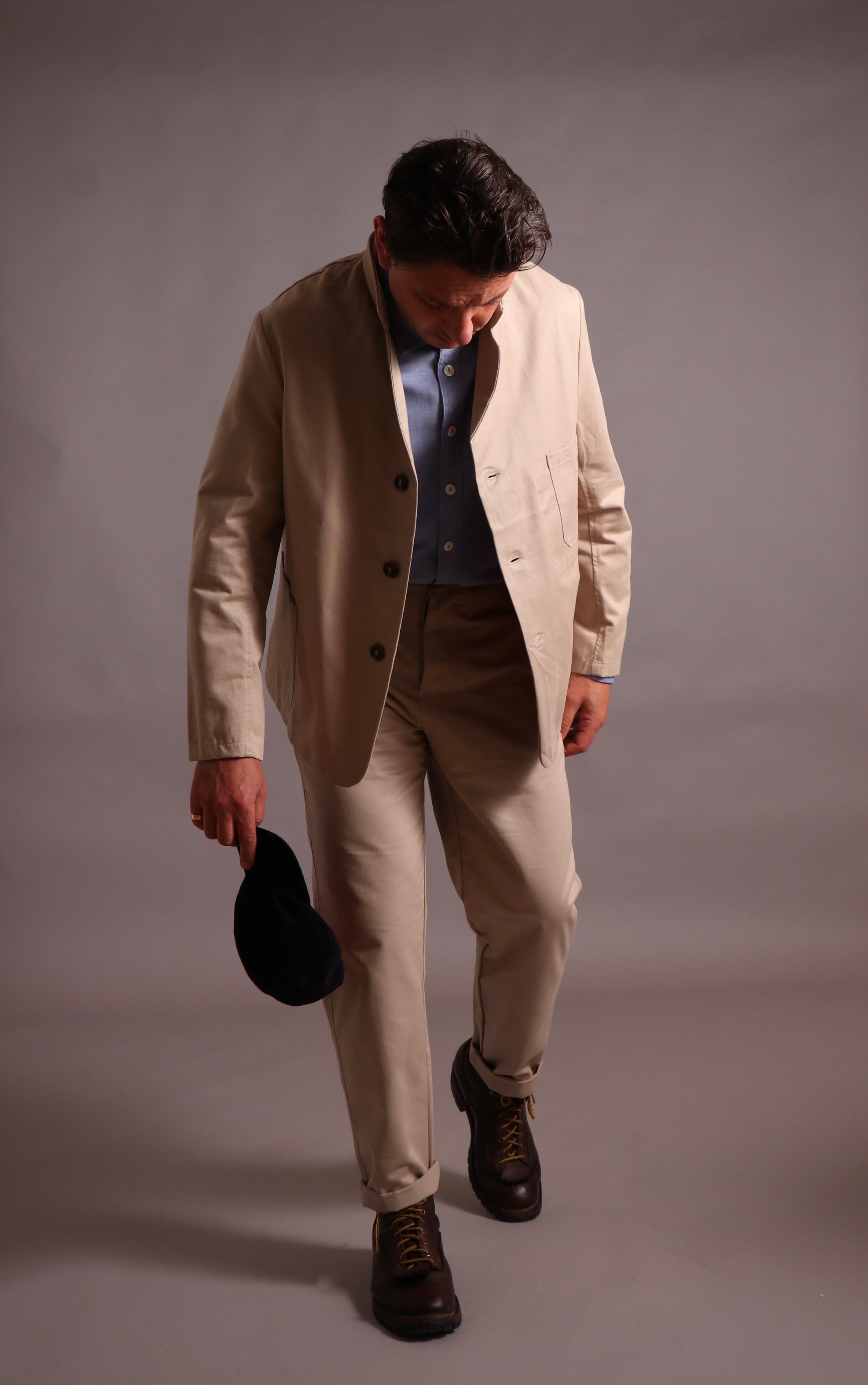 Enzo wears High Waist Trousers with Three Button Jacket and Pinpoint Chambray Shirt