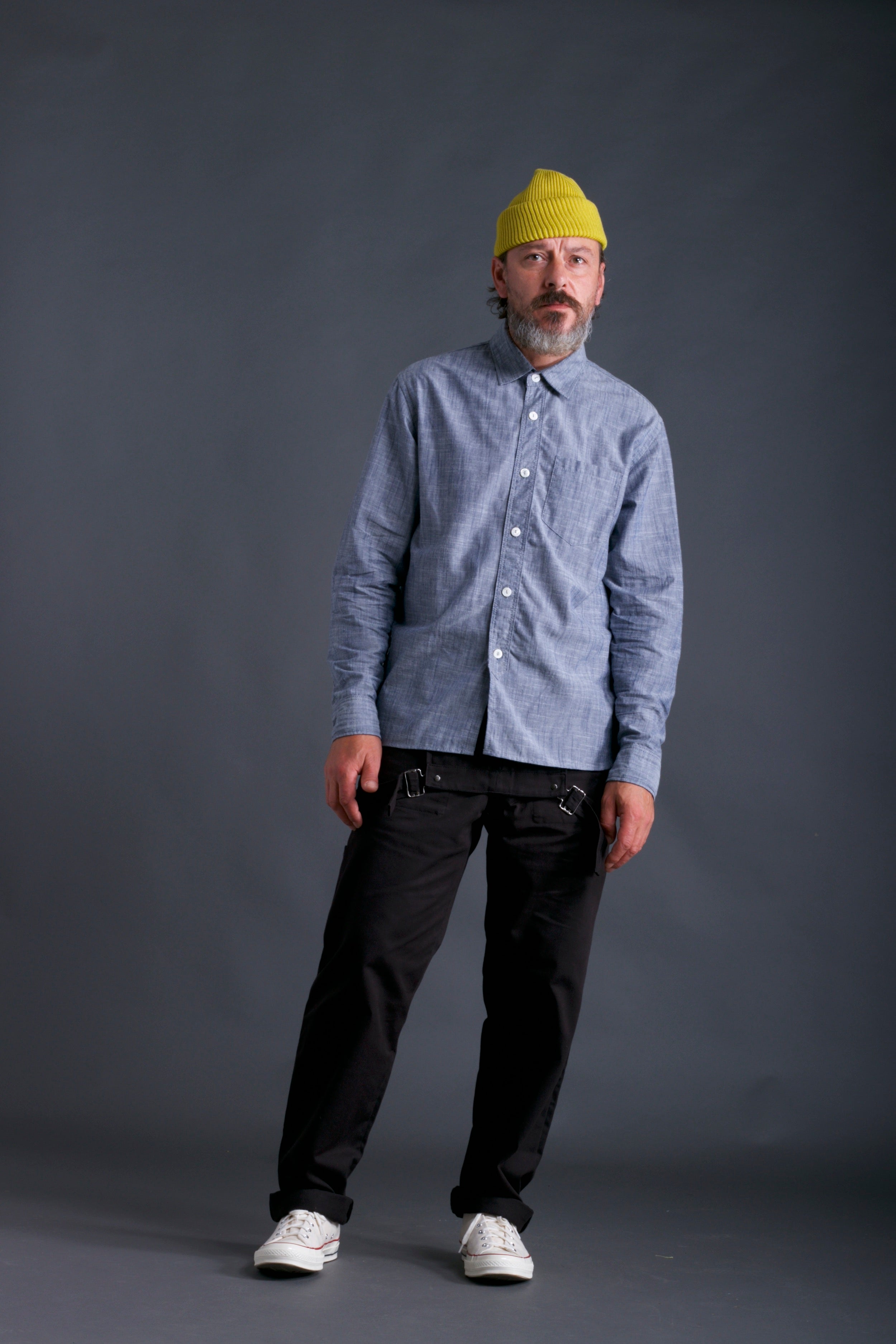 Man wearing Carrier Company Dungarees in Black with Chambray Shirt and Yellow Wool Merino Hat