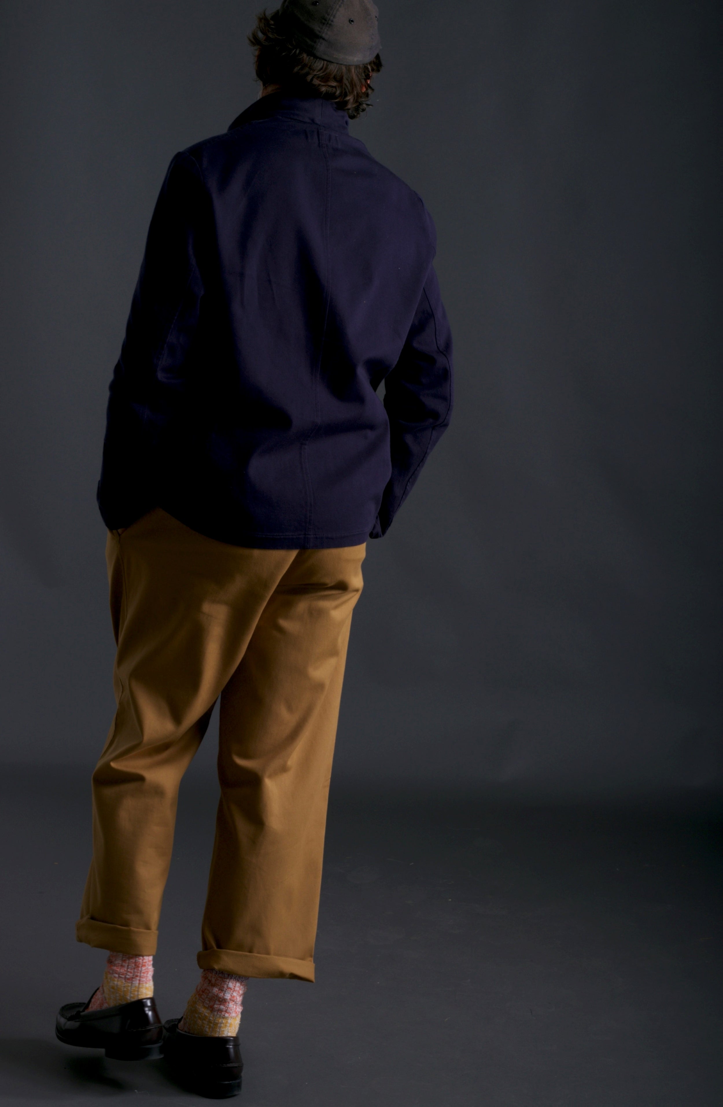 Man wears Carrier Company Classic Trouser in Tan, Three Button Jacket in Navy and Salmon Wool Walking Socks