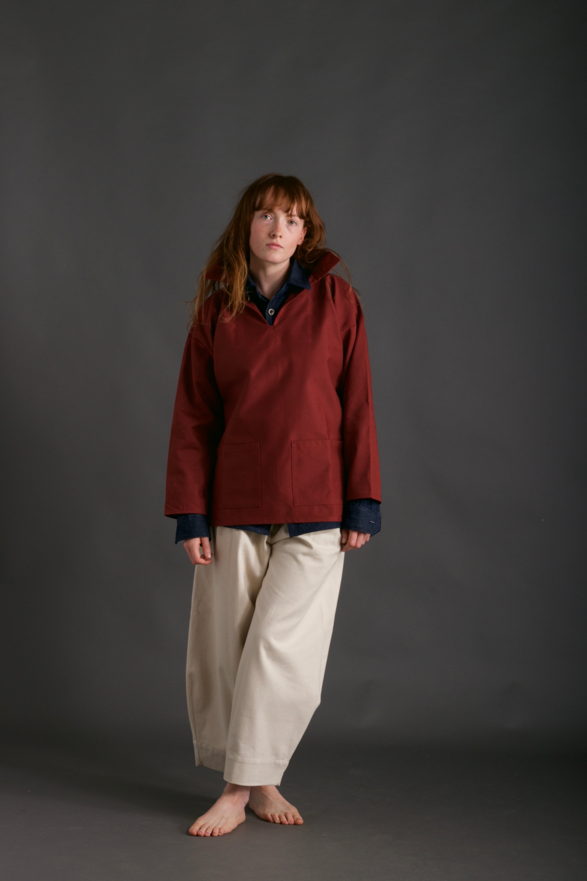 Woman wears Carrier Company V-Neck Smock in Terracotta with Denim Collar Shirt and Dutch Trouser in Seeded Denim
