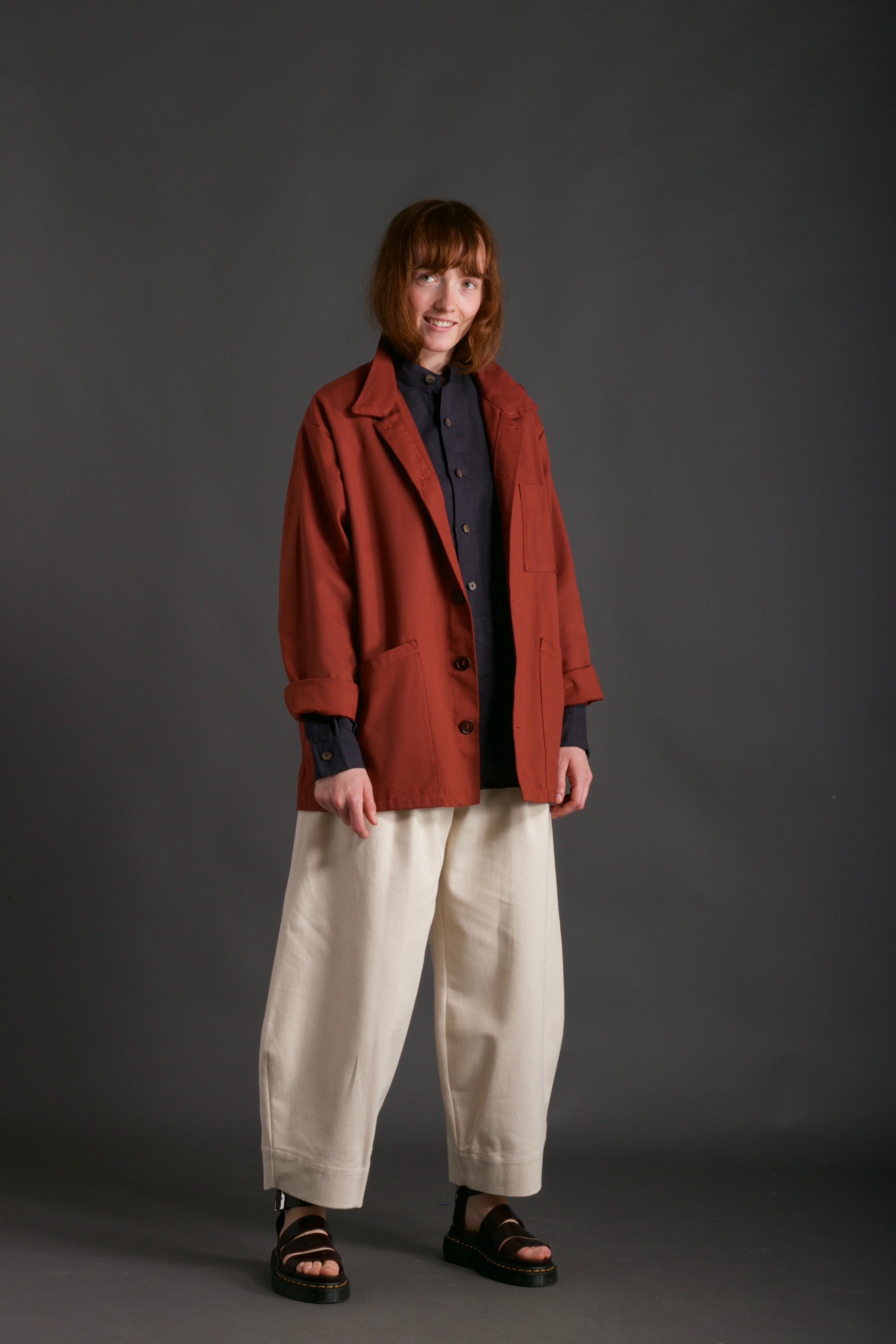 Woman wears Norfolk Work Jacket in Breton with Navy Linen Collarless Shirt and Dutch Trouser in Seeded Denim