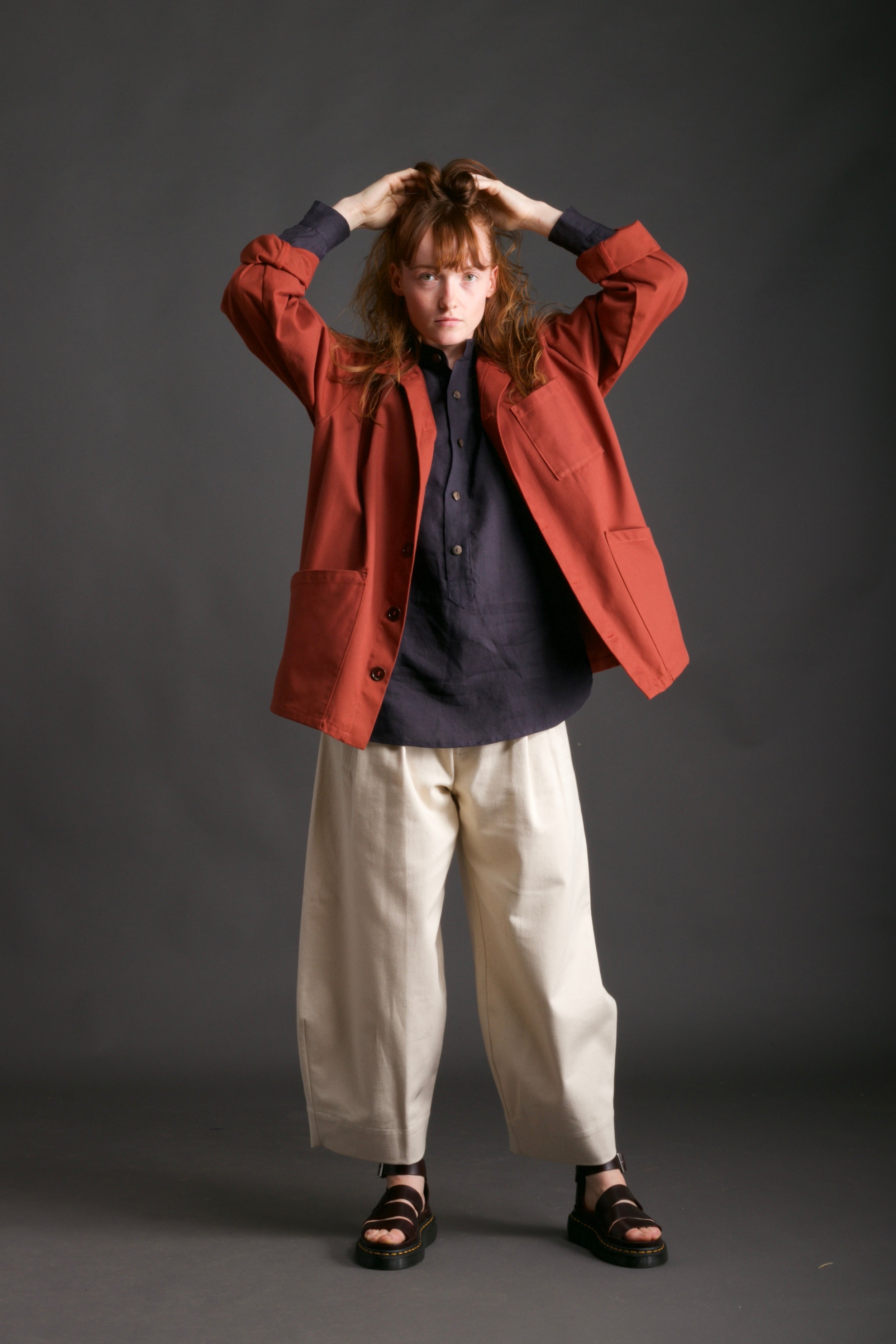 Woman wears Norfolk Work Jacket in Breton with Navy Linen Collarless Shirt and Dutch Trouser in Seeded Denim