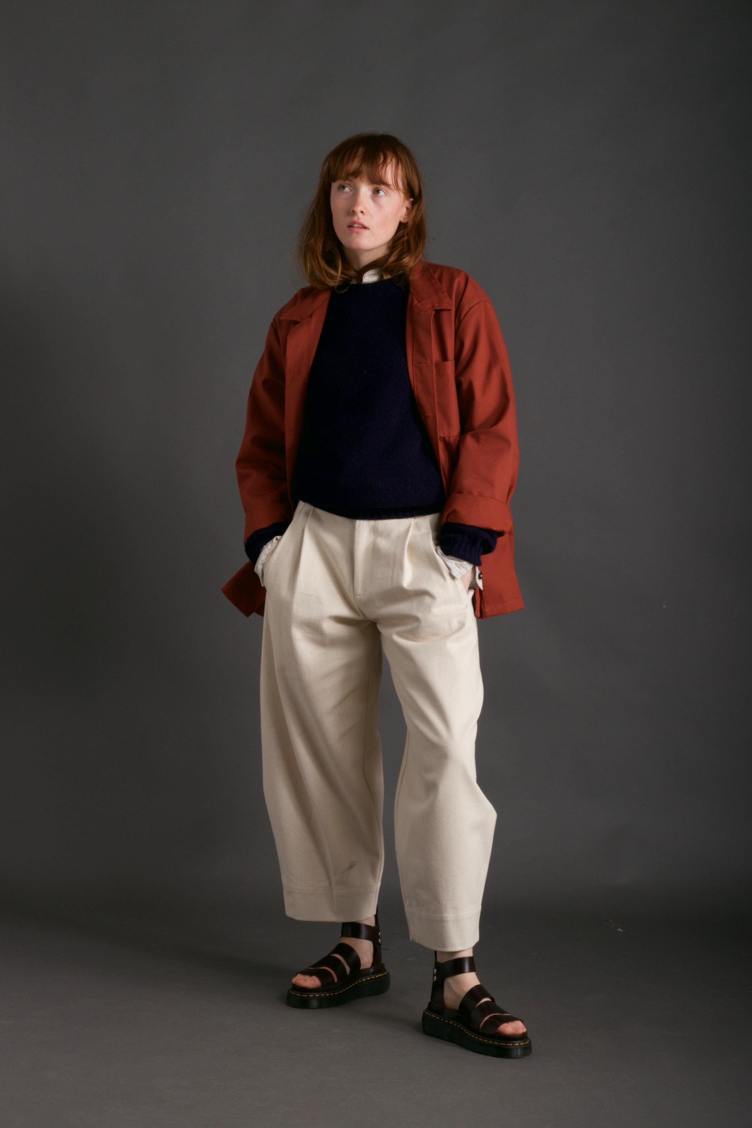 Woman wears Norfolk Work Jacket in Breton with Navy Linen Collarless Shirt and Dutch Trouser in Seeded Denim