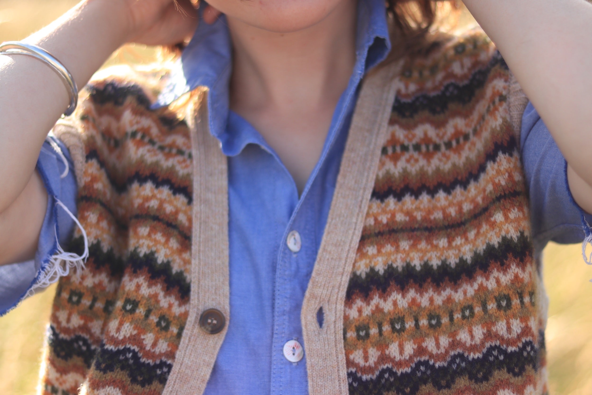 Minna wears Carrier Company Sleeveless Fair Isle Cardigan with Pinpoint Chambray Shirt