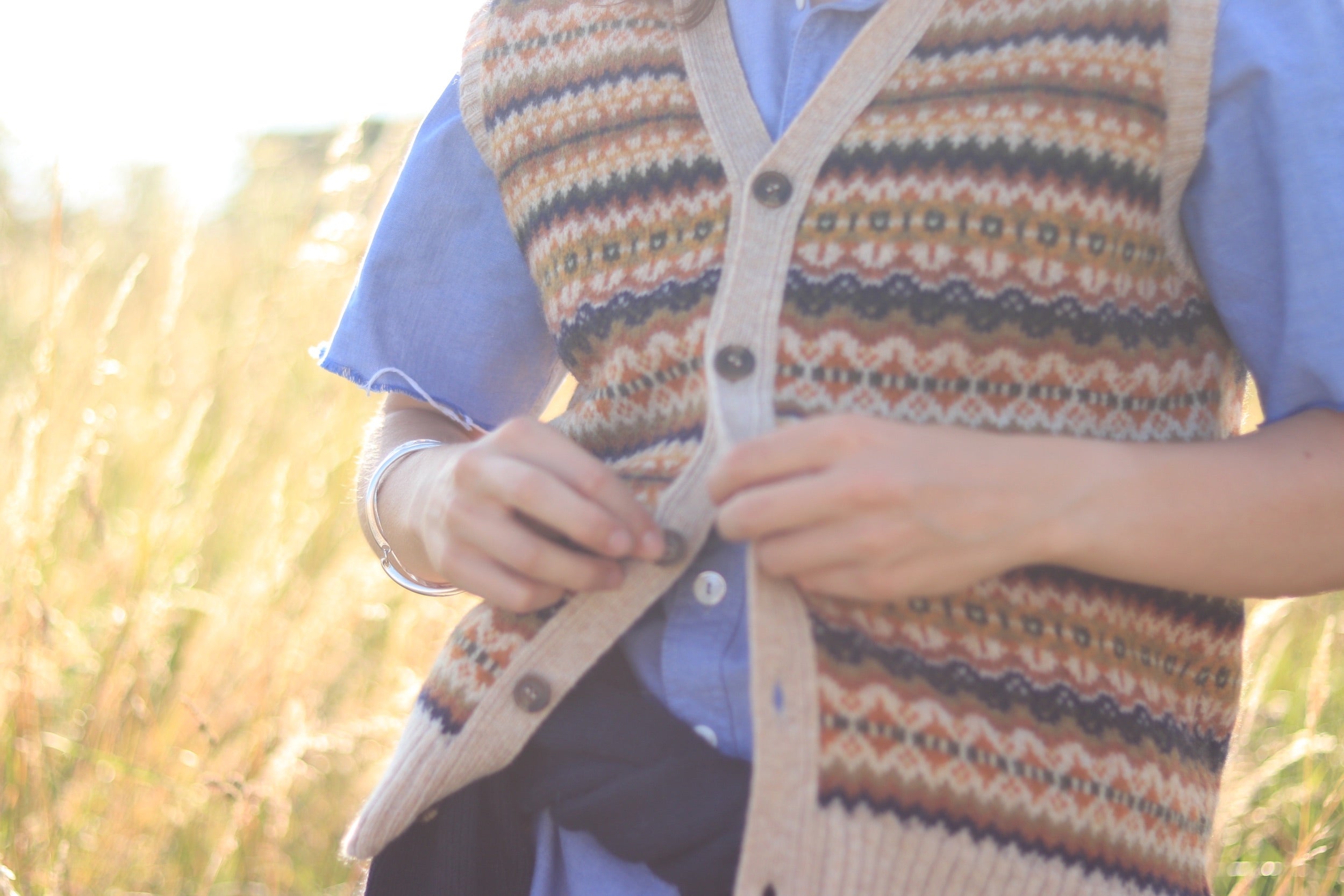 Minna wears Carrier Company Sleeveless Fair Isle Cardigan with Pinpoint Chambray Shirt