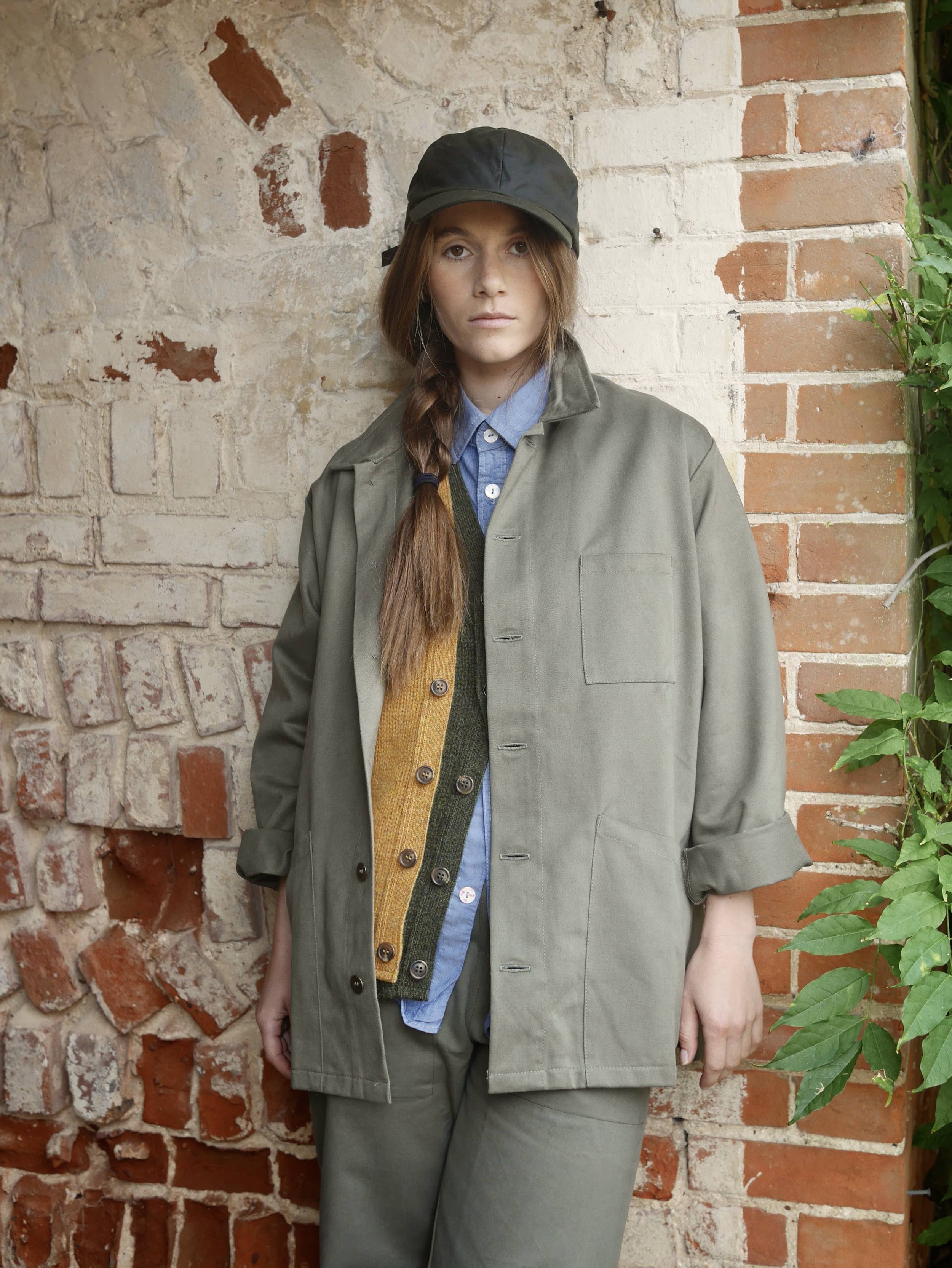 ecca wears Carrier Company Norfolk Work jacket with Sleeveless Cardigans, Pinpoint Chambray Shirt, Oilskin Cap and Women's Work Trouser