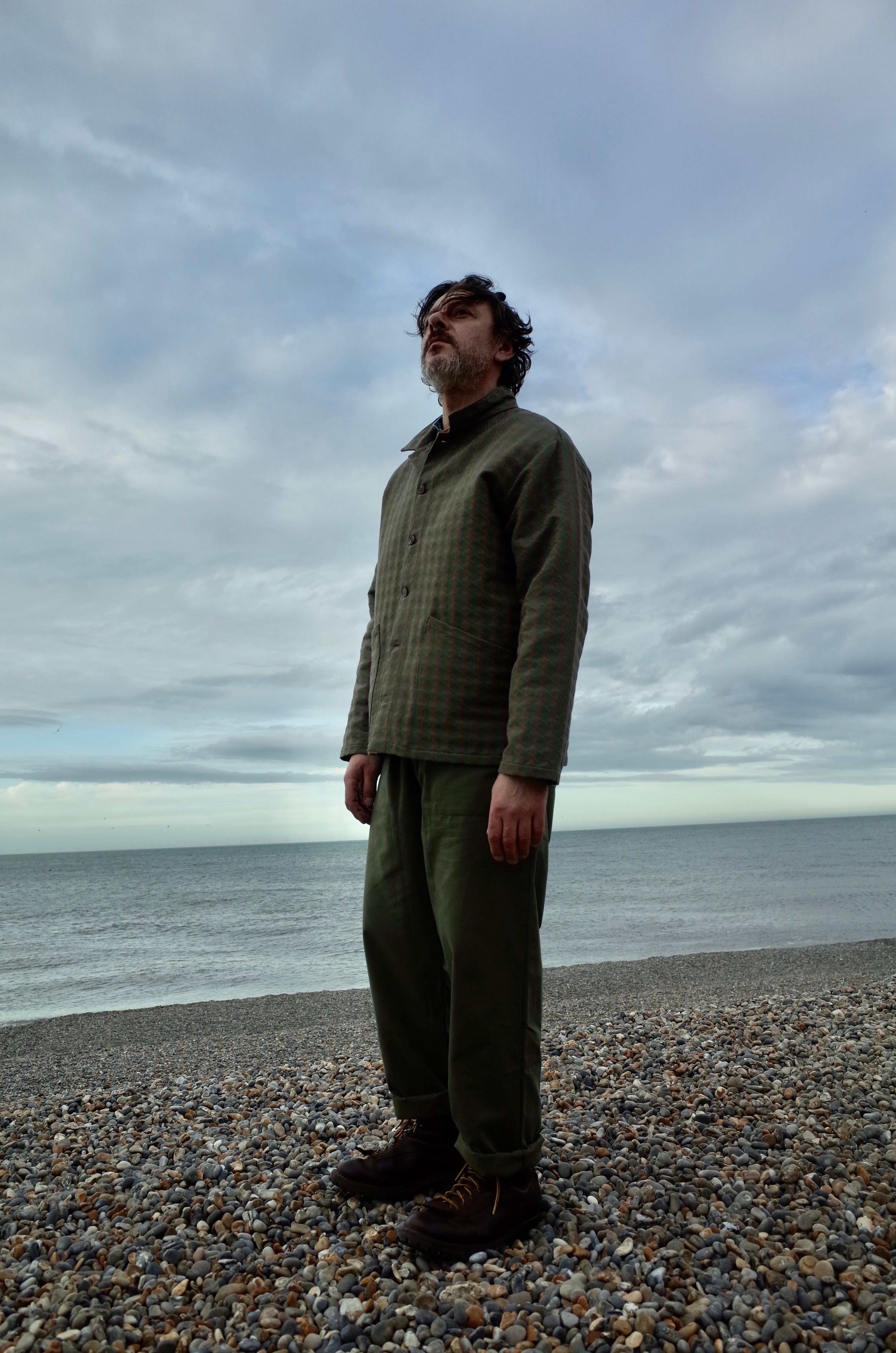 Man wears Carrier Company x Flora Soames Norfolk Work Jacket in Heather Walt with Olive Men's Work Trouser