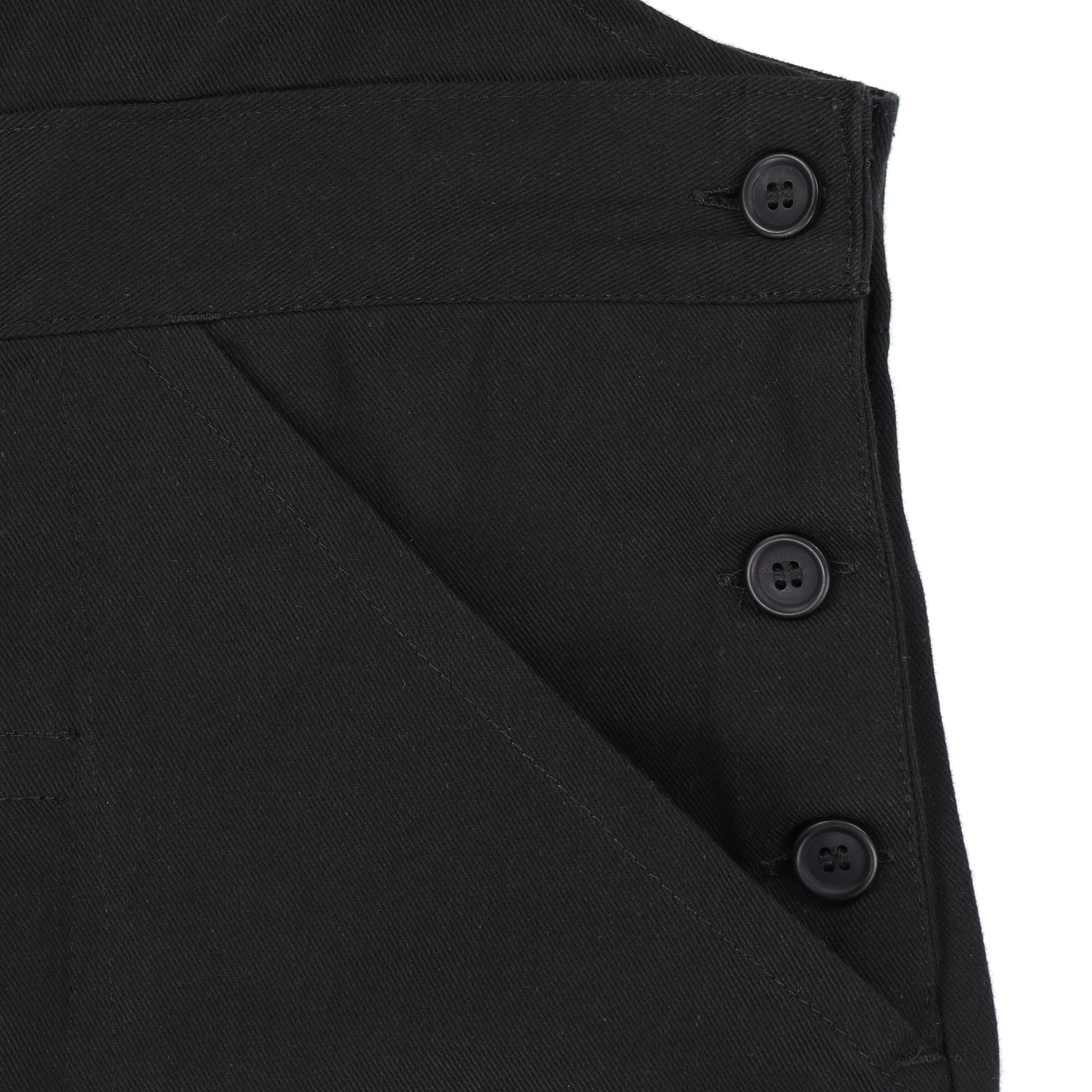 Close up of the button detail and pockets of the black Carrier Company Men's Dungarees