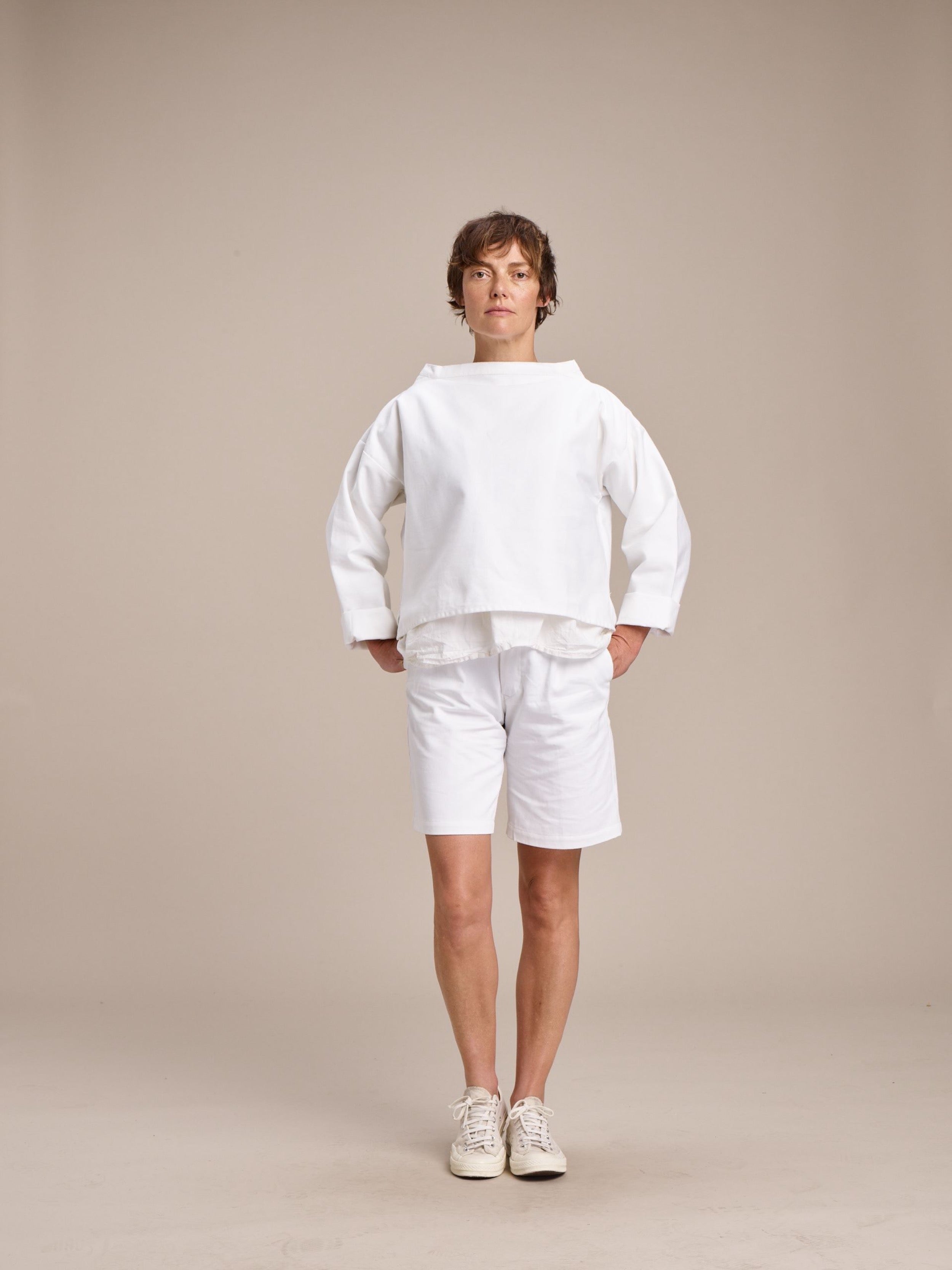 Woman wears Carrier Company Cropped Smock in White with Cotton Tee Shirt and Ladies Short in White