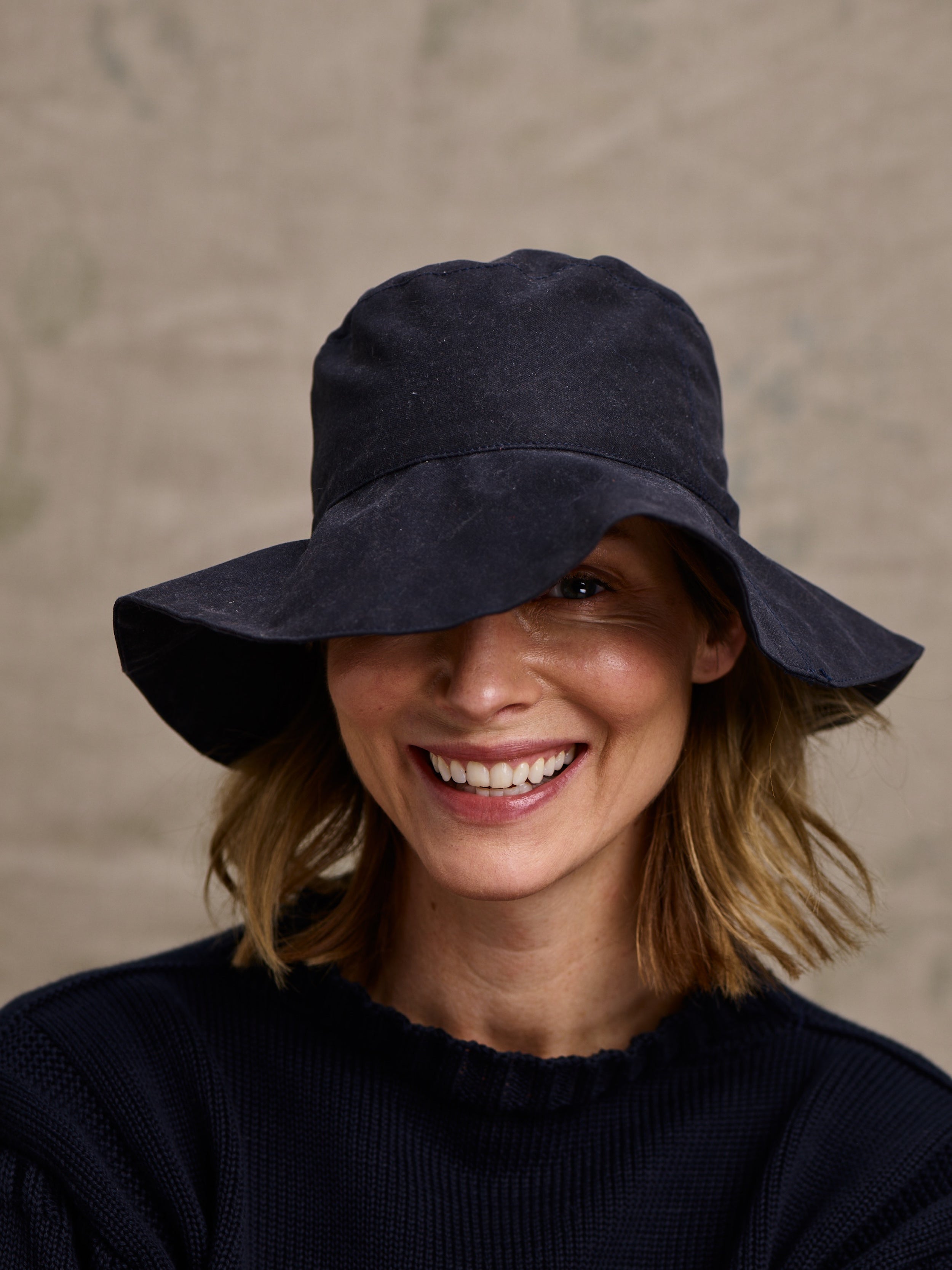 Woman wearing Carrier Company Waxed Cotton Hat in Navy