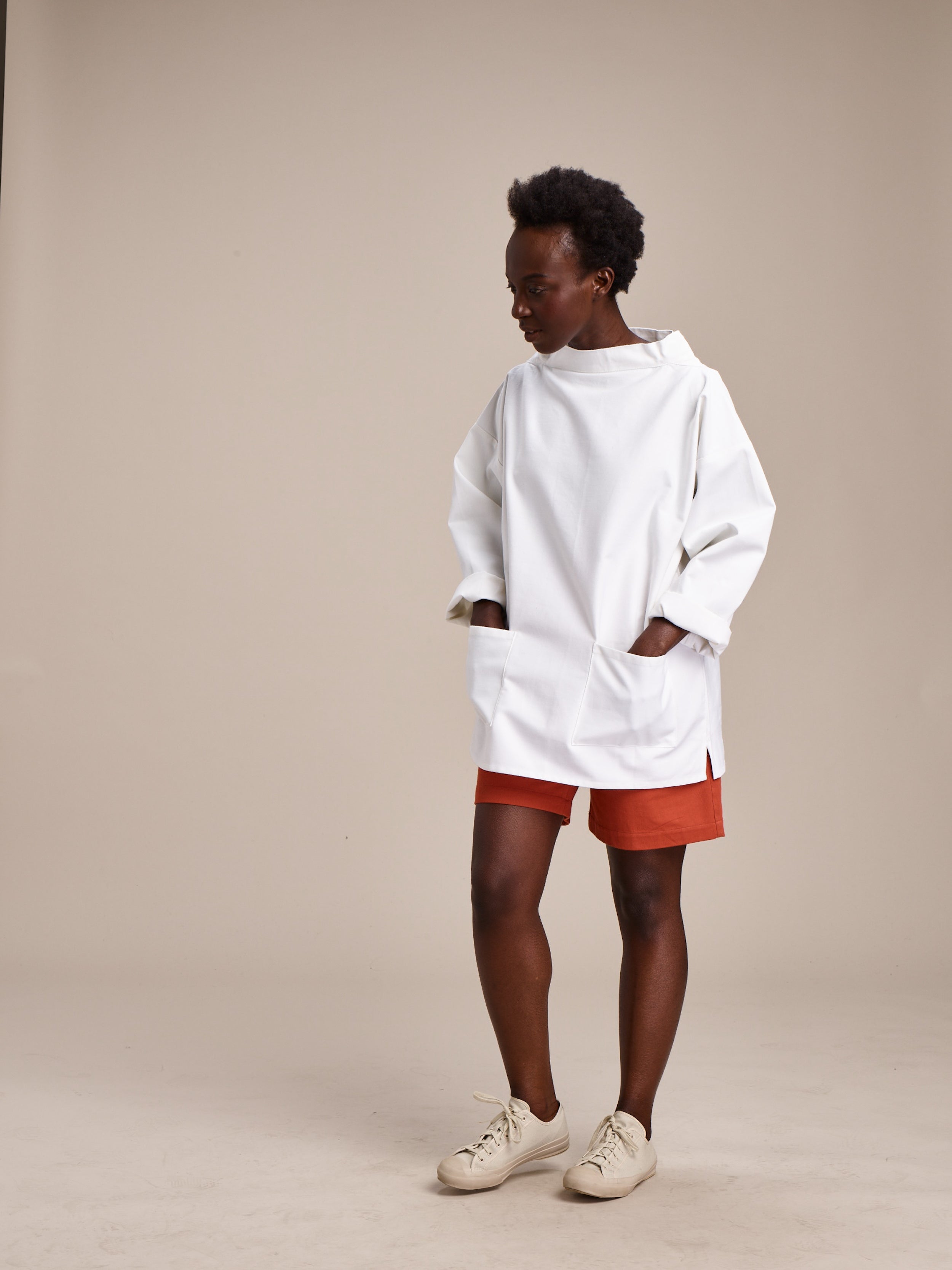 Woman wearing Carrier Company Traditional Norfolk Slop in White and Ladies Shorts in Orange