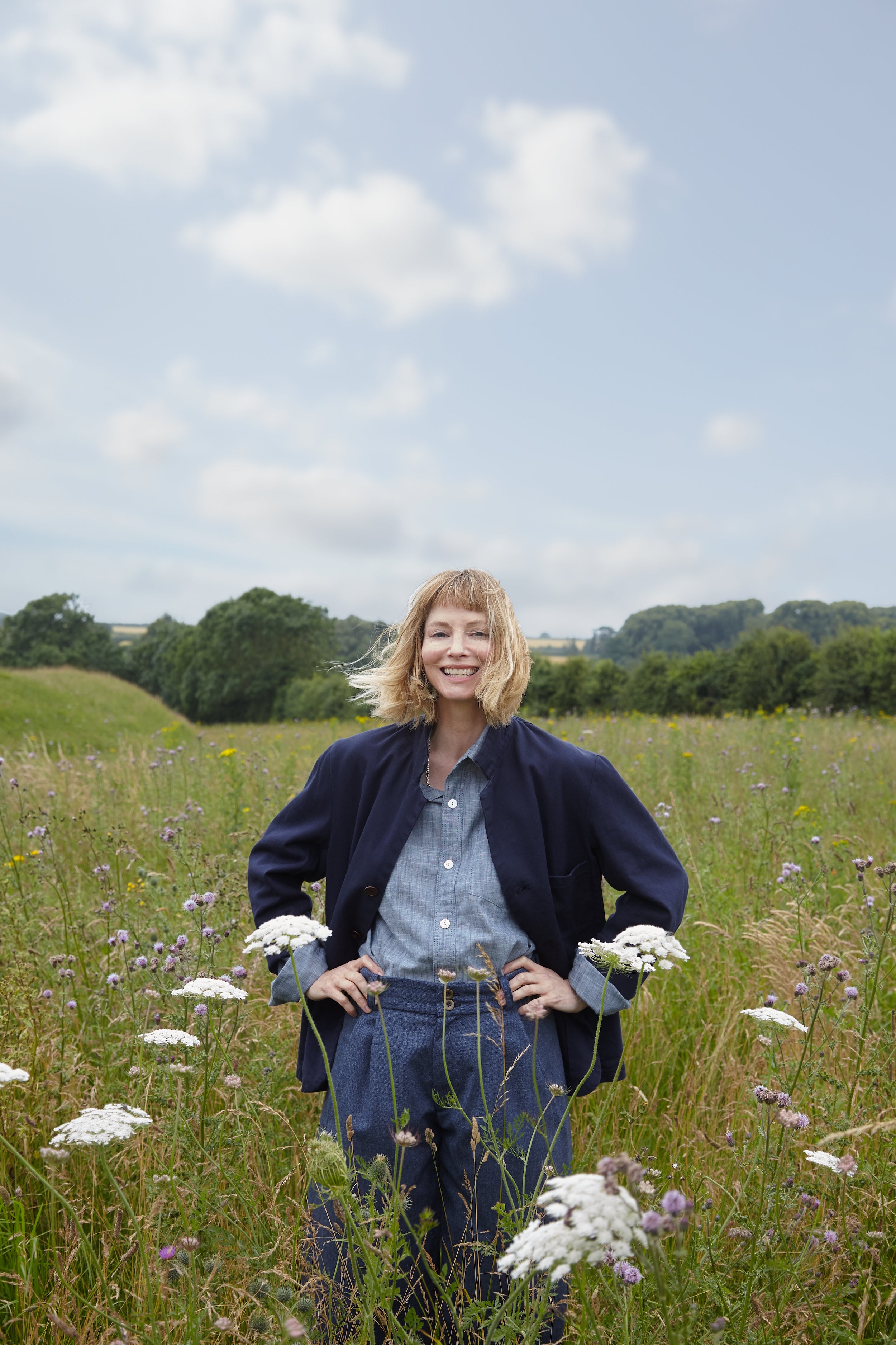 Woman wears Carrier Company 3 Button Jacket in Navy Drill with Dutch Trouser in Wool, Chambray Shirt