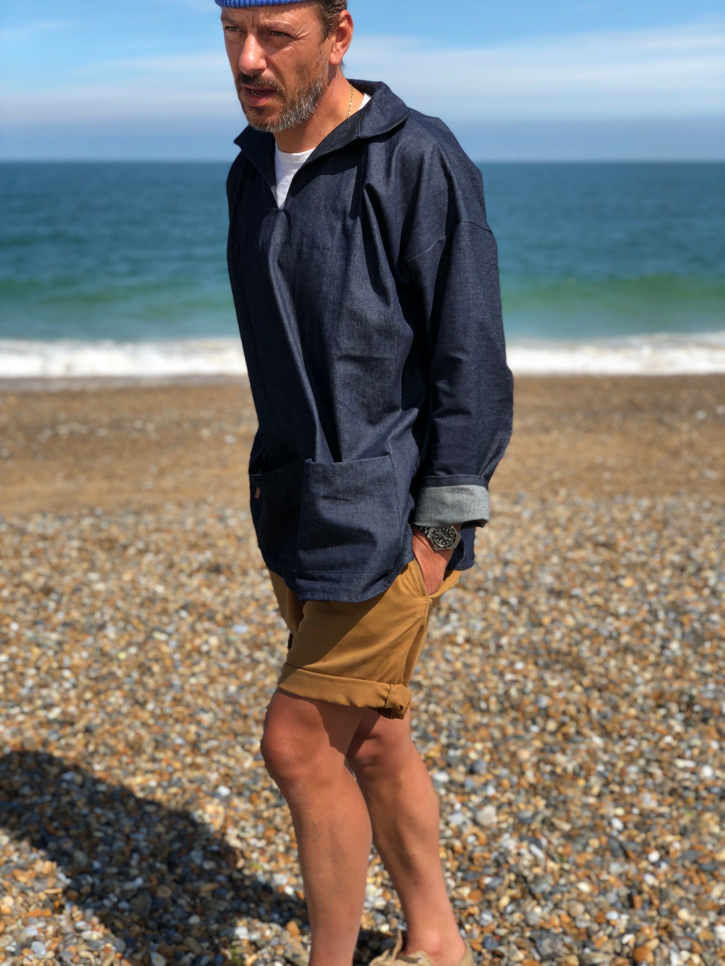 Man wearing Carrier Company V-Neck Smock in Denim and Tan Grandpa Shorts