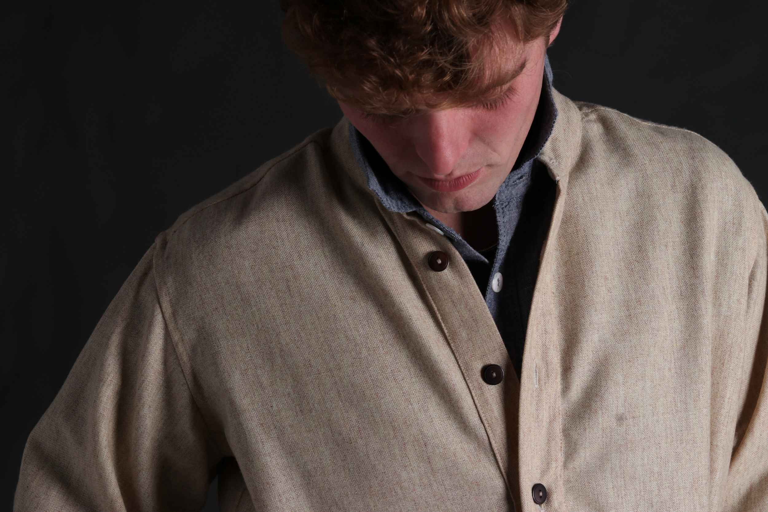 Man wears Carrier Company Wool Overshirt in Barleystraw with Chambray Shirt underneath