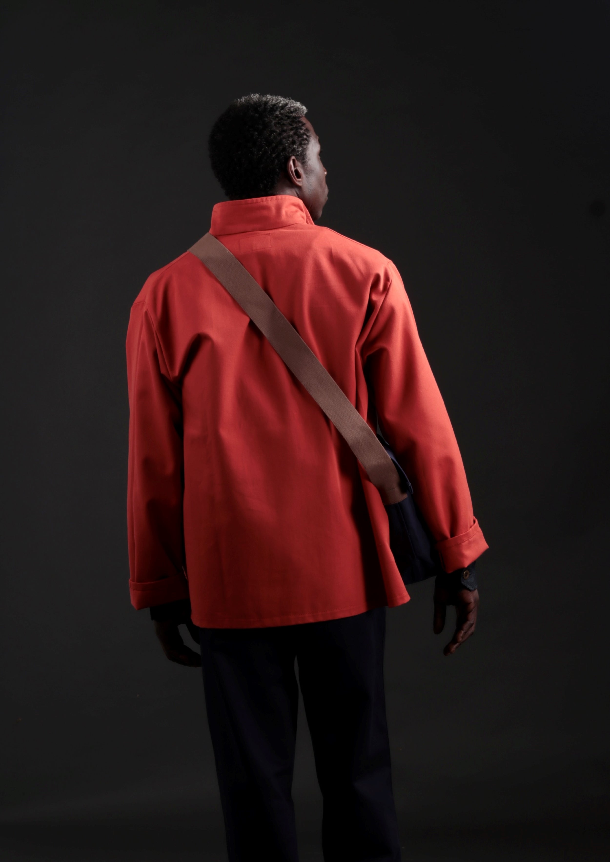 Man carries a Carrier Company Canvas Satchel in Navy