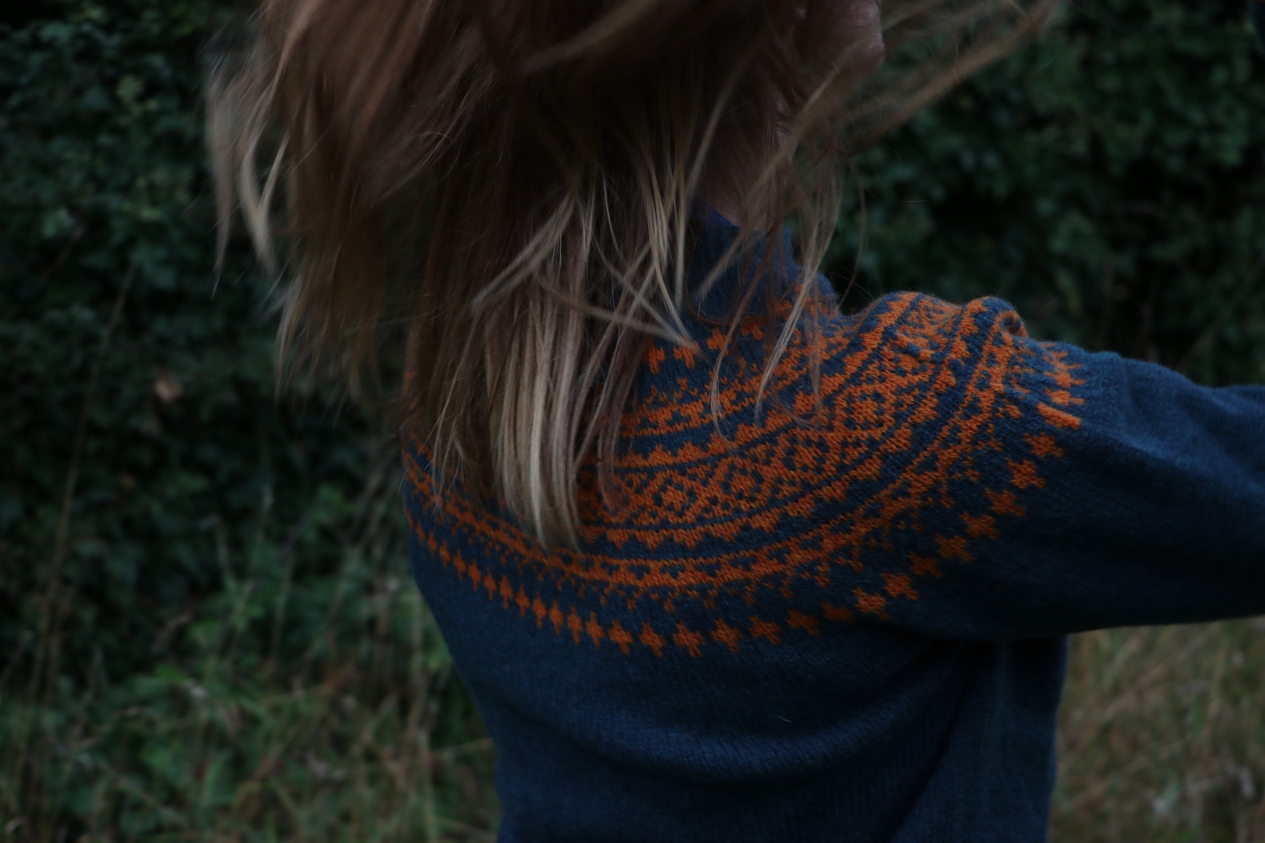 Woman wearing Carrier Company Shetland Lambswool Yoke Jumper in Ginger and Teal with tan Women's Work Trouser