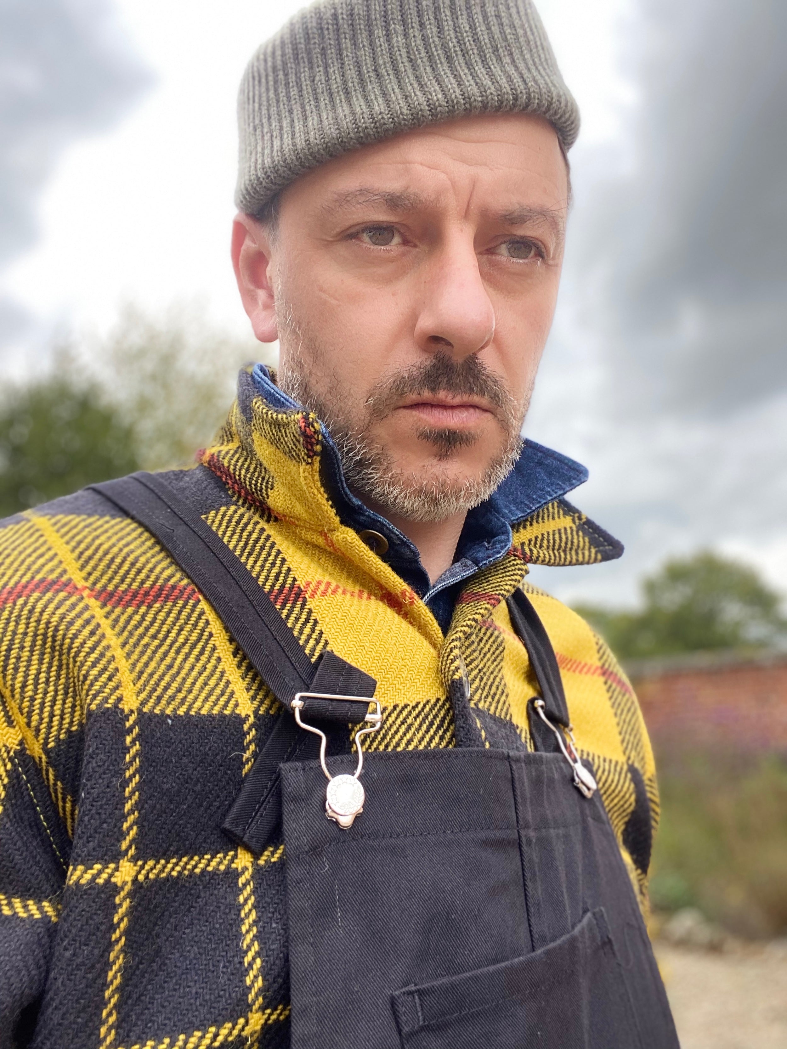 Man wears Carrier Company Wool Hat in Olive Drab with Celtic Wool Jacket