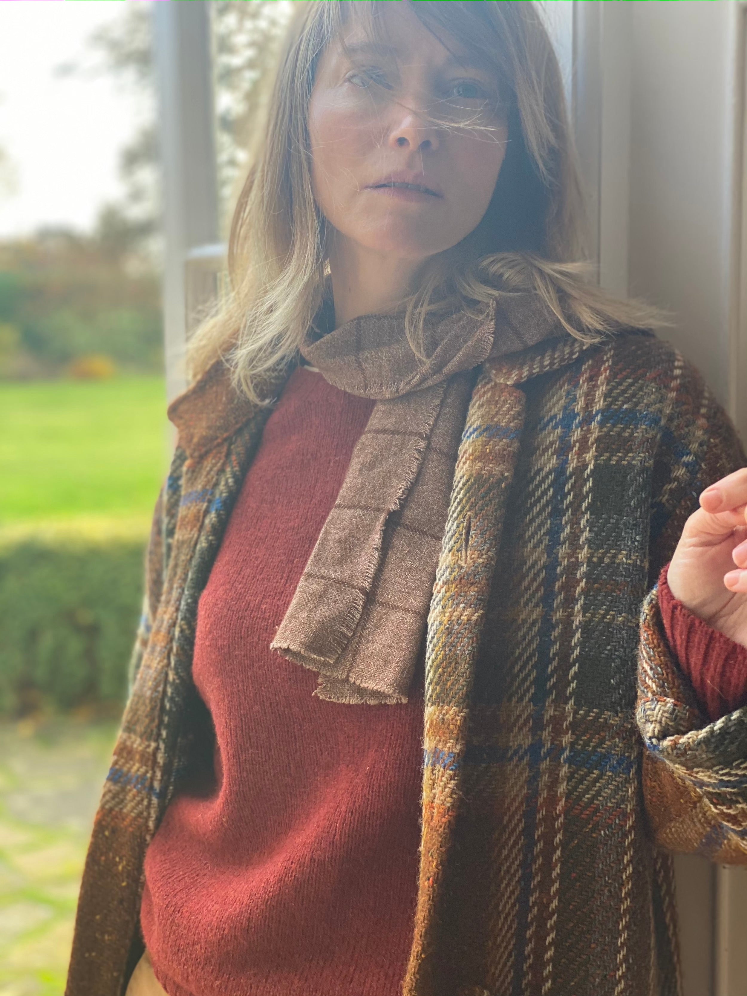 Woman wearing Carrier Company shetland Lambswool Jumper in Blaze and Celtic Wool Jacket in Russet