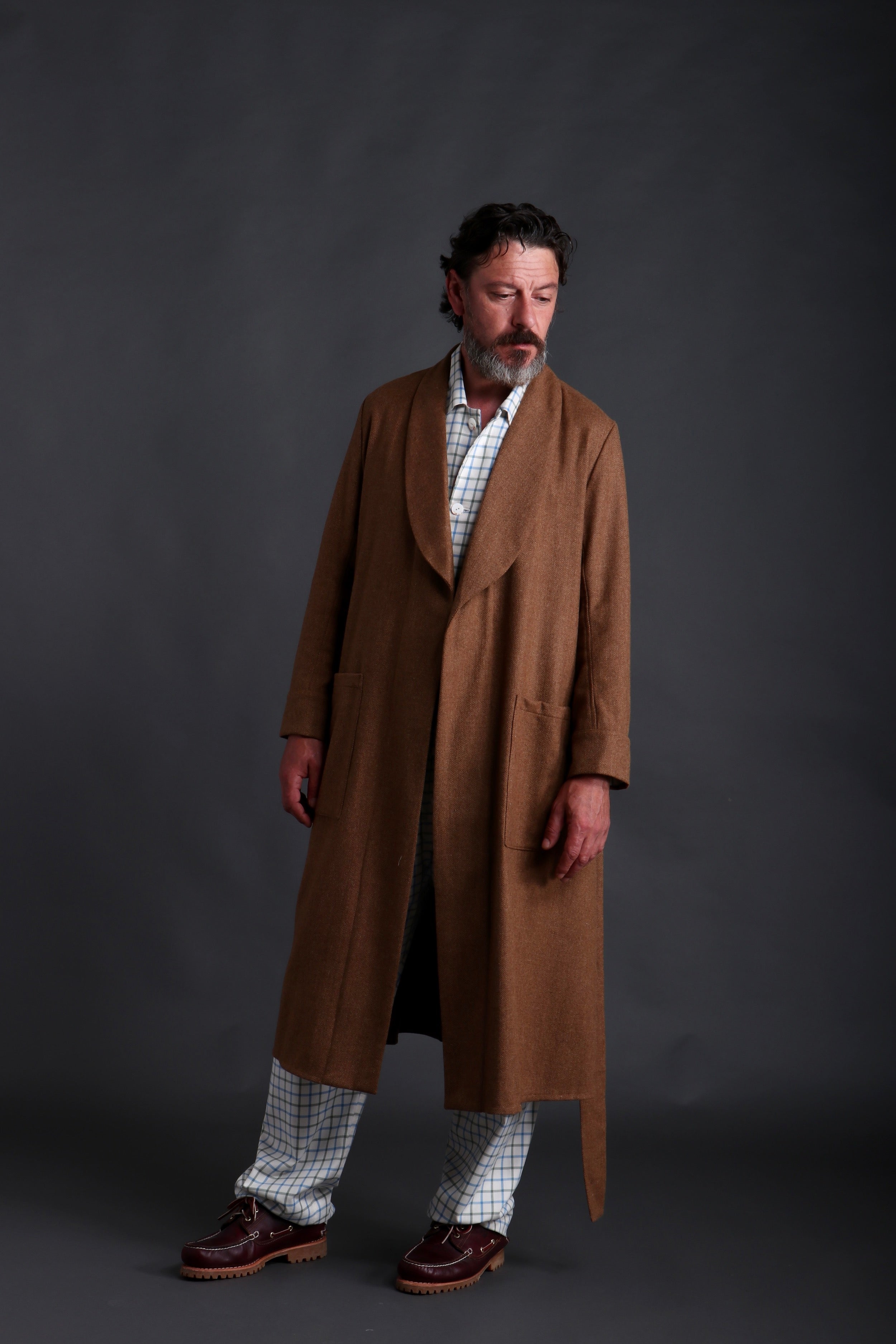 Man wears Carrier Company Wool Dressing Gown in Tan Herringbone