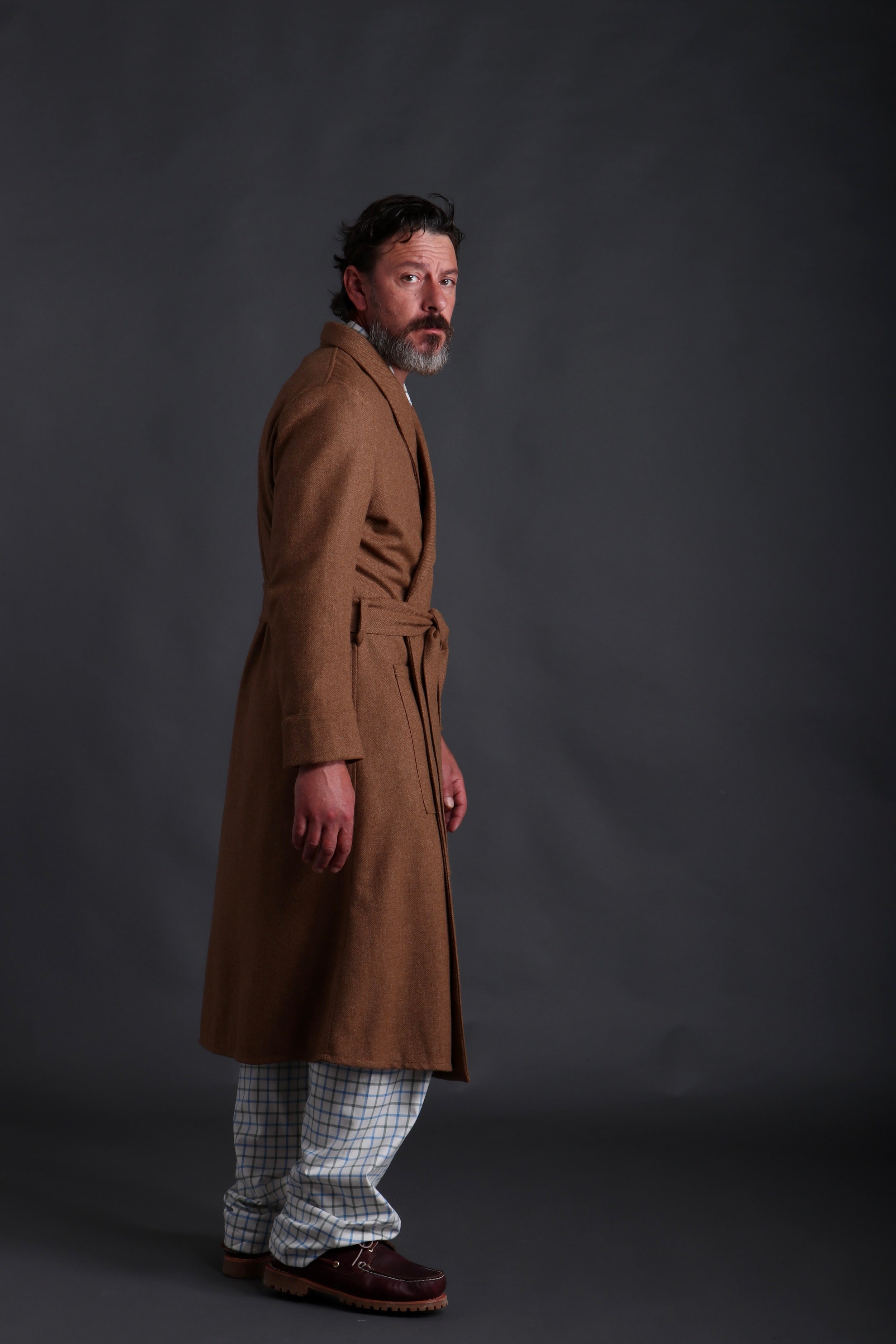 Man wears Carrier Company Wool Dressing Gown in Tan Herringbone