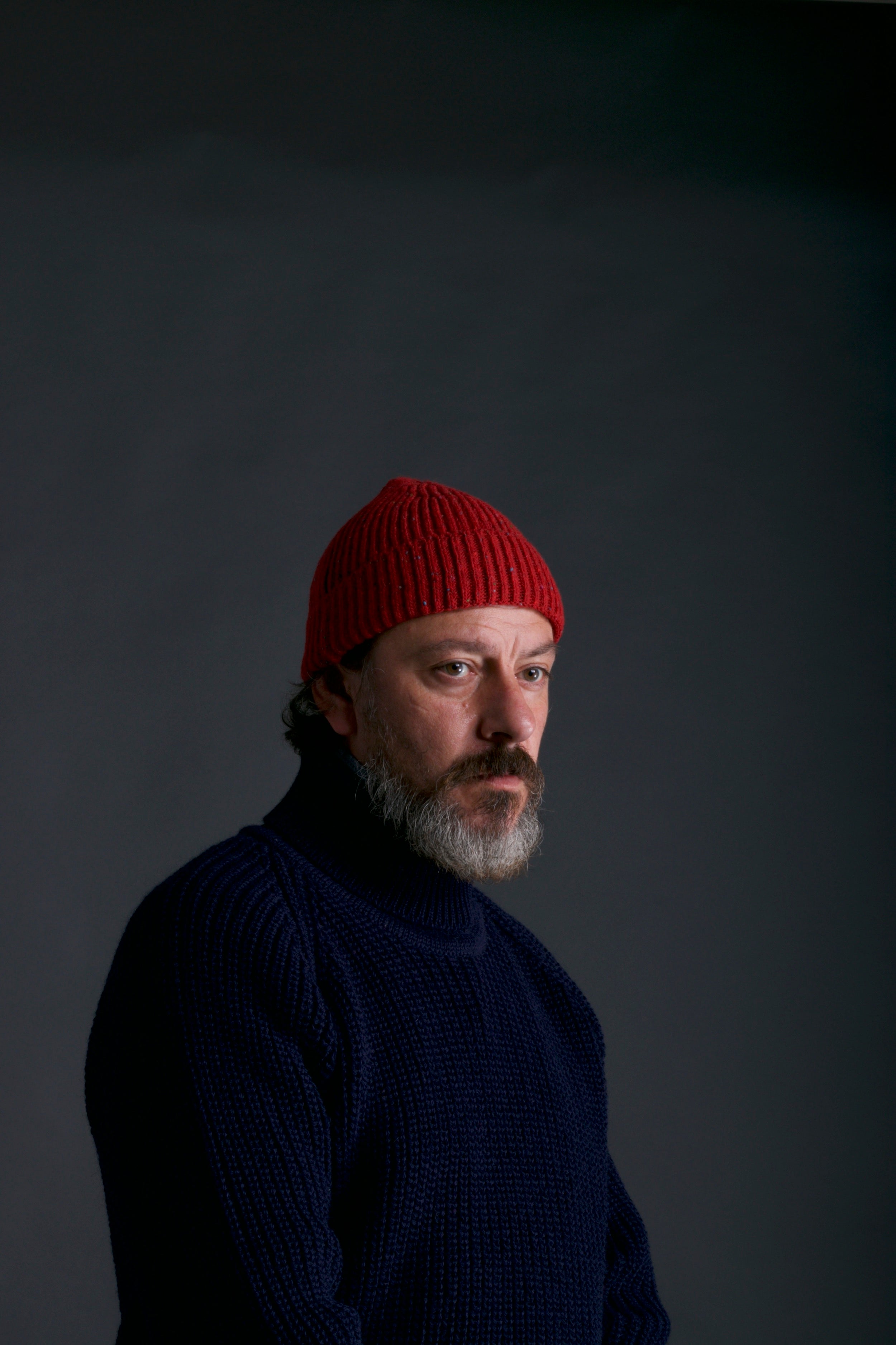 Man wears Carrier Company Donegal Wool Hat and Fisherman's jumper in Navy