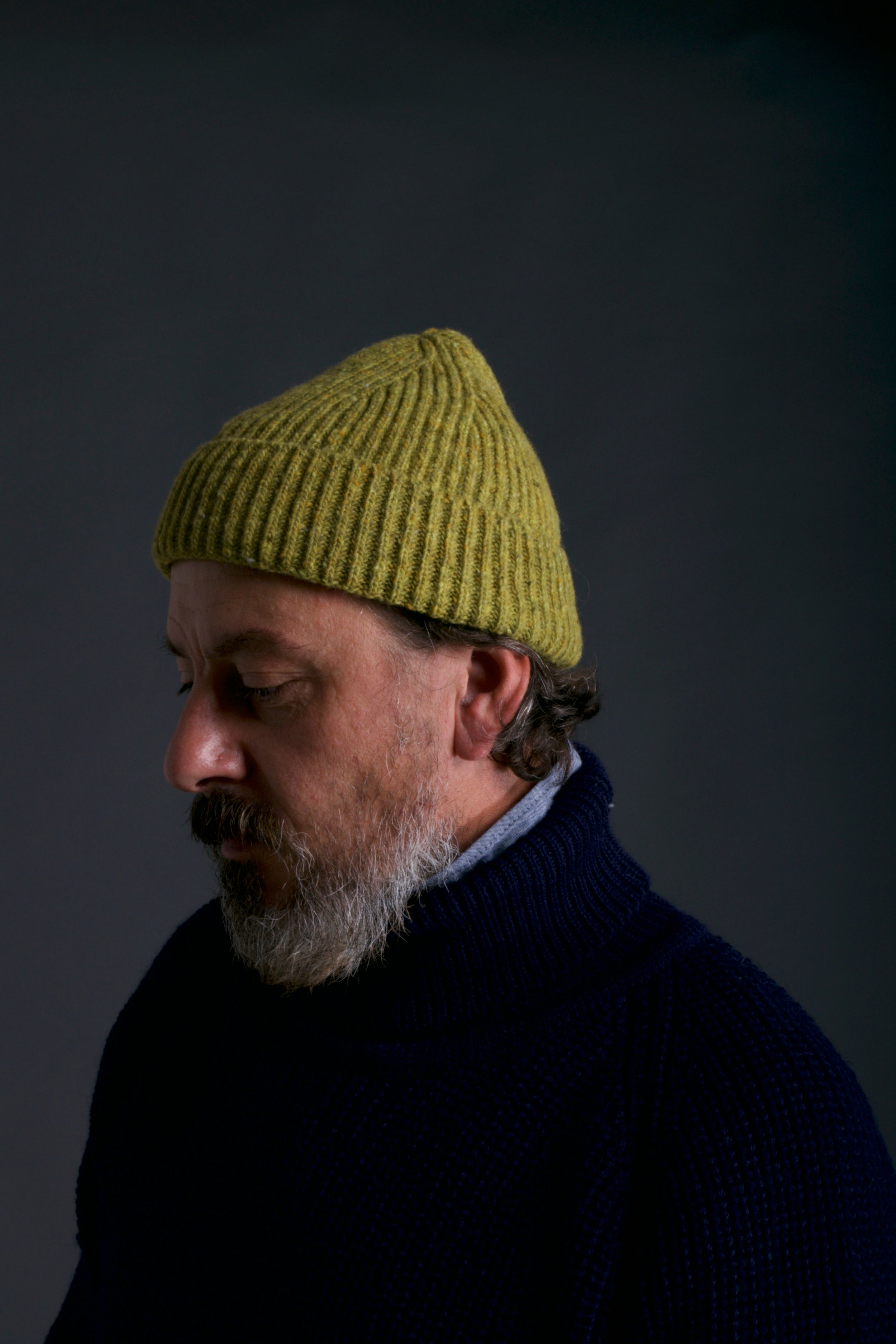 Man wears Carrier Company Donegal Wool Hat in Pistacchio with Navy Fisherman's Jumper