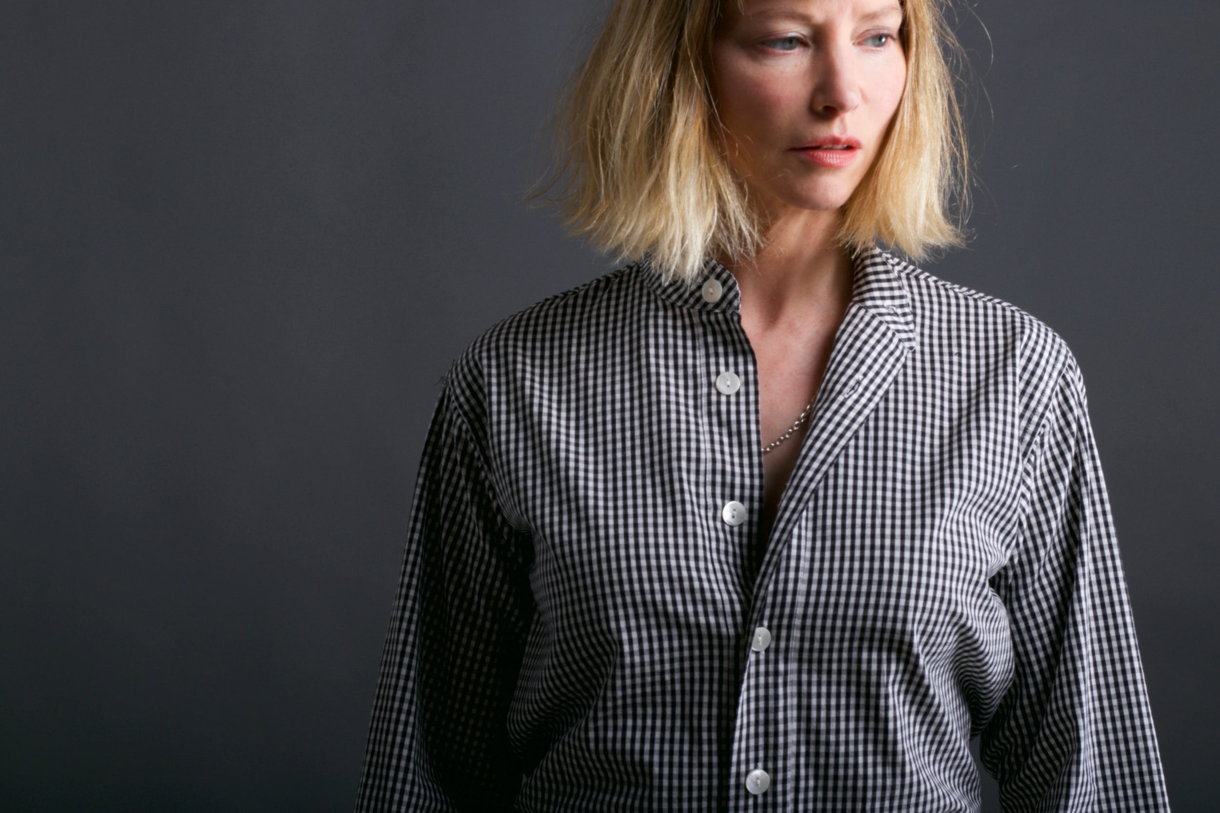 Woman wears Carrier Company Collarless Shirt in Black Gingham
