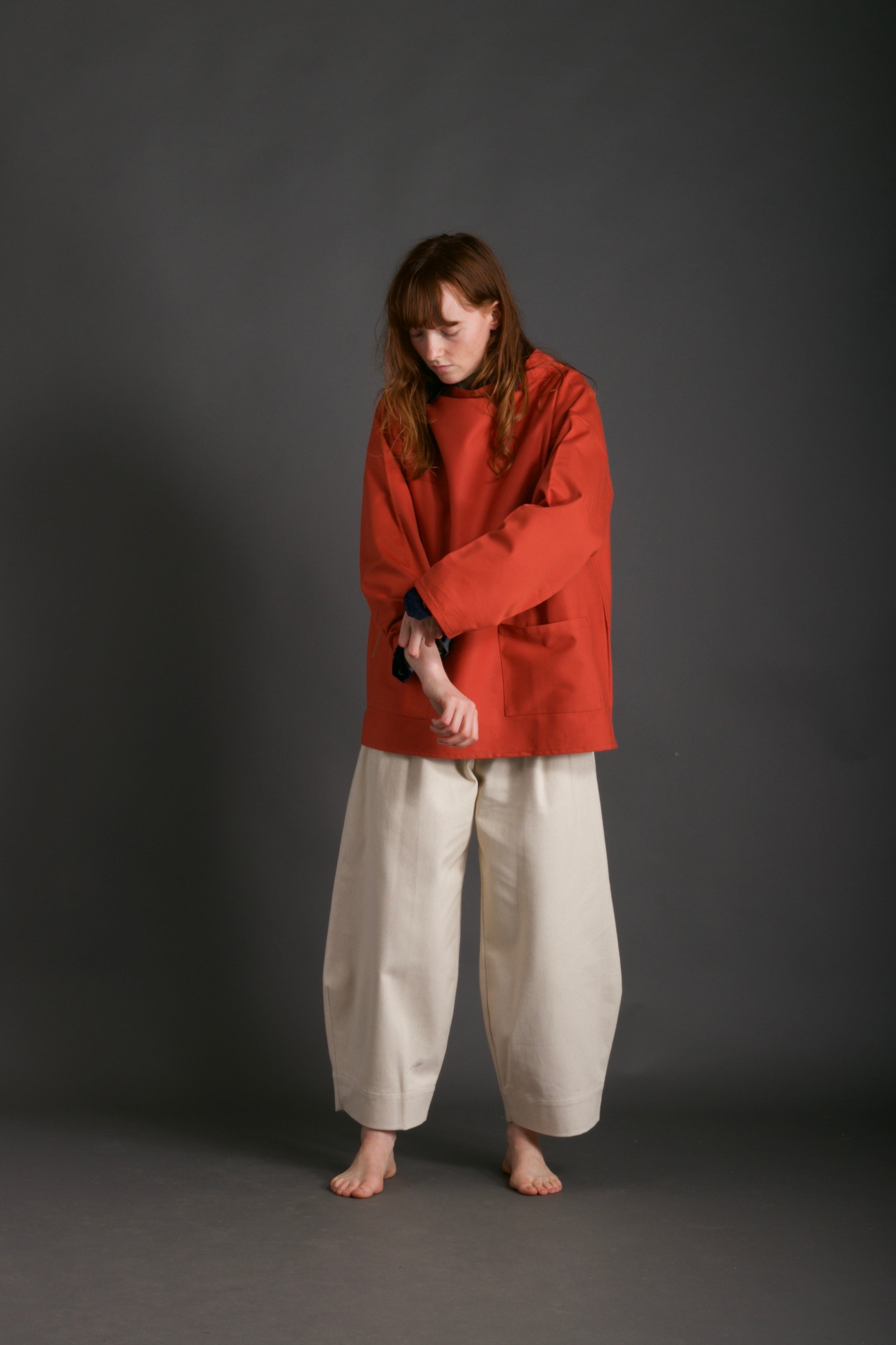 Woman wears Carrier Company Traditional Norfolk Slop in Orange and Dutch Trouser in Seeded Denim