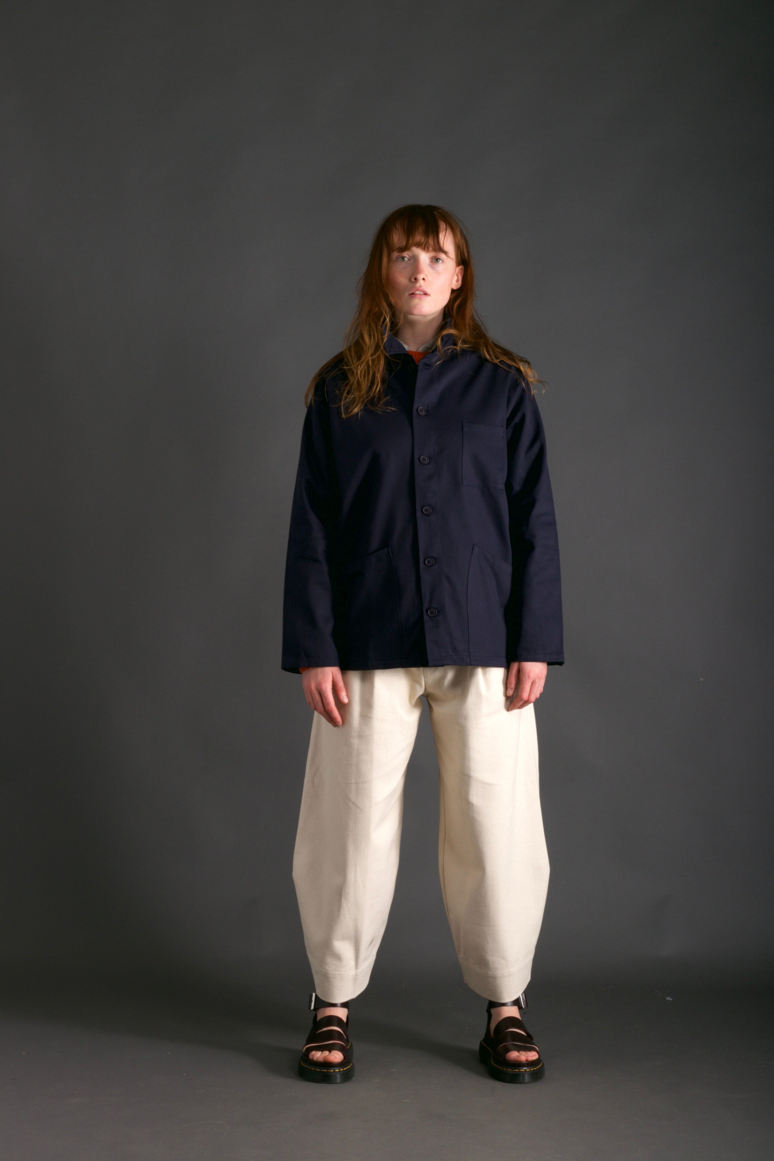 Woman wearing Carrier Company Traditional Norfolk Work Jacket in Navy and Dutch Trouser in Seeded Denim