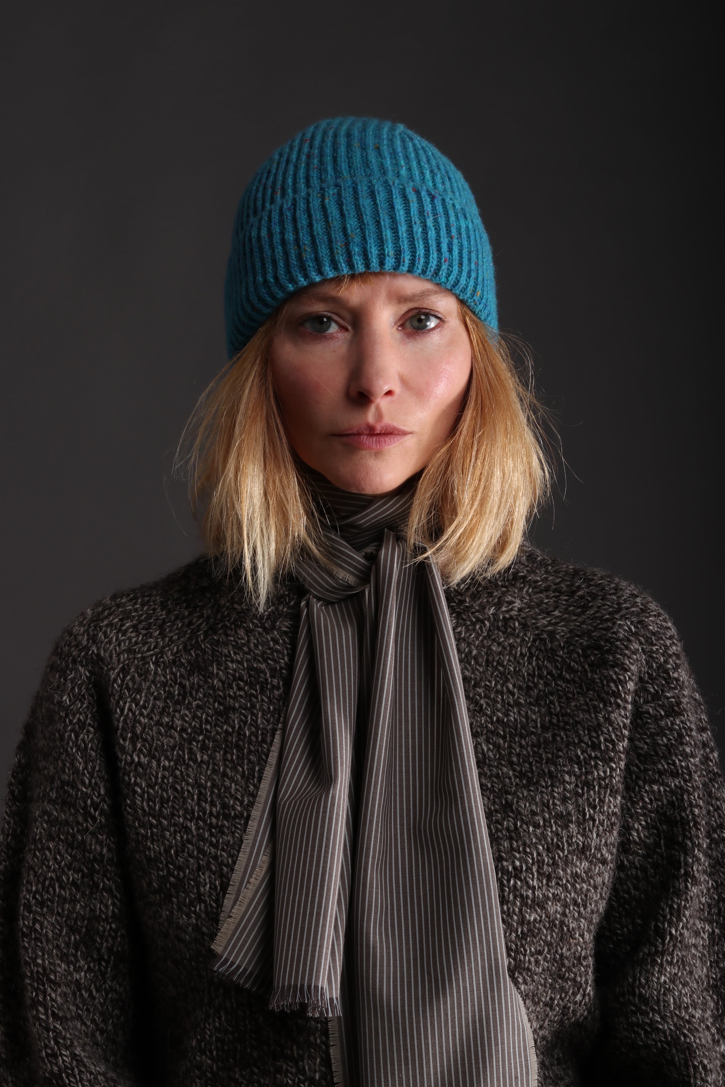 Woman wears Carrier Company Donegal Wool Hat in Turquoise with Heavy Heritage Lambswool Jumper