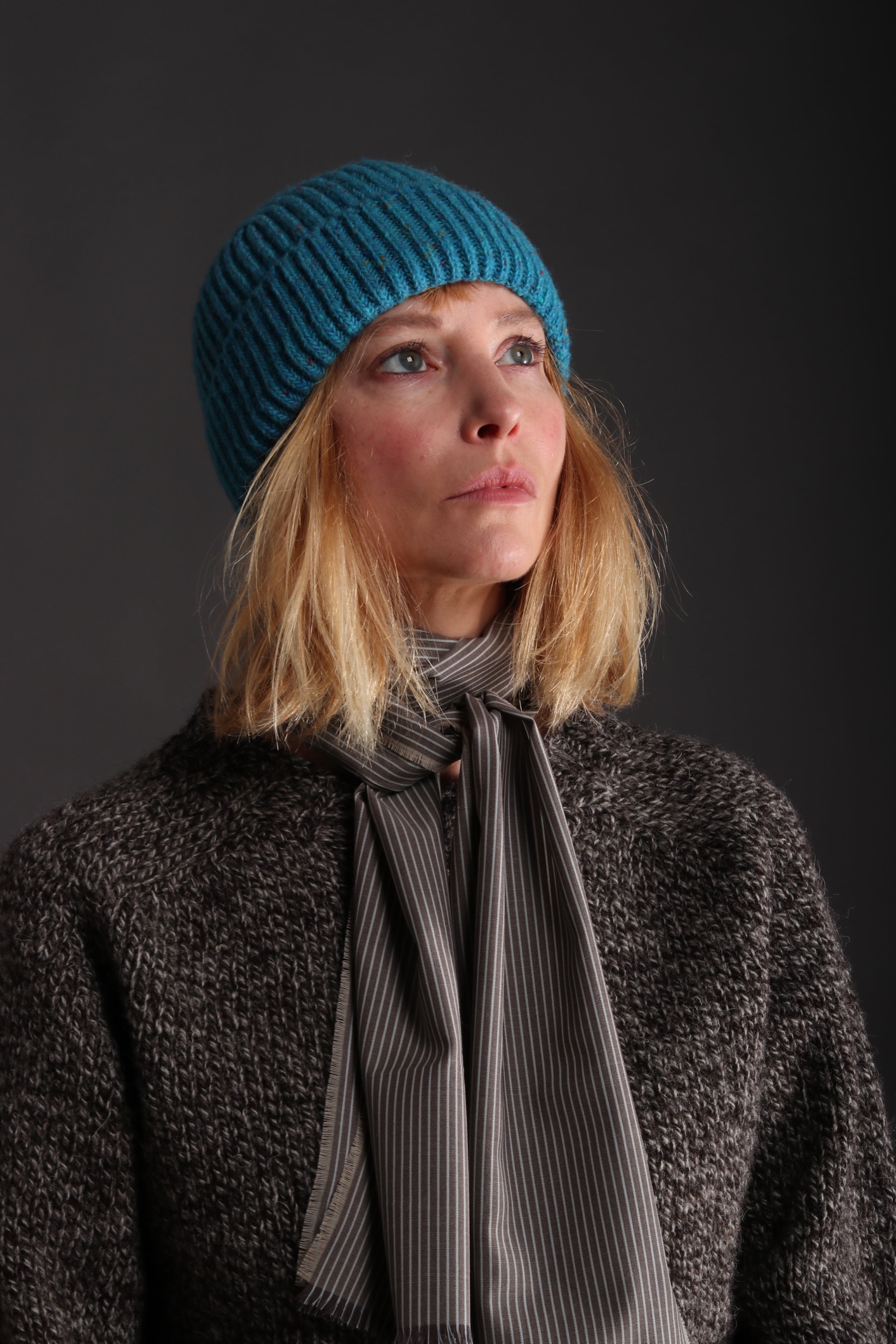 Woman wears Carrier Company Donegal Wool Hat in Turquoise with Heavy Heritage Lambswool Jumpe