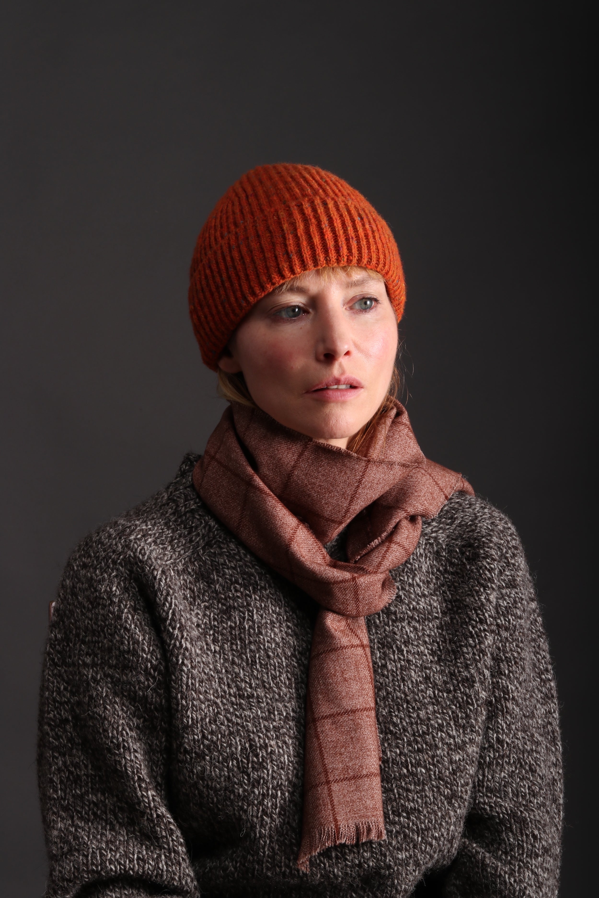 Woman wearing Tangerine Donegal Wool Hat with Heavy Heritage Lambswool Jumper and Checked Short Scarf