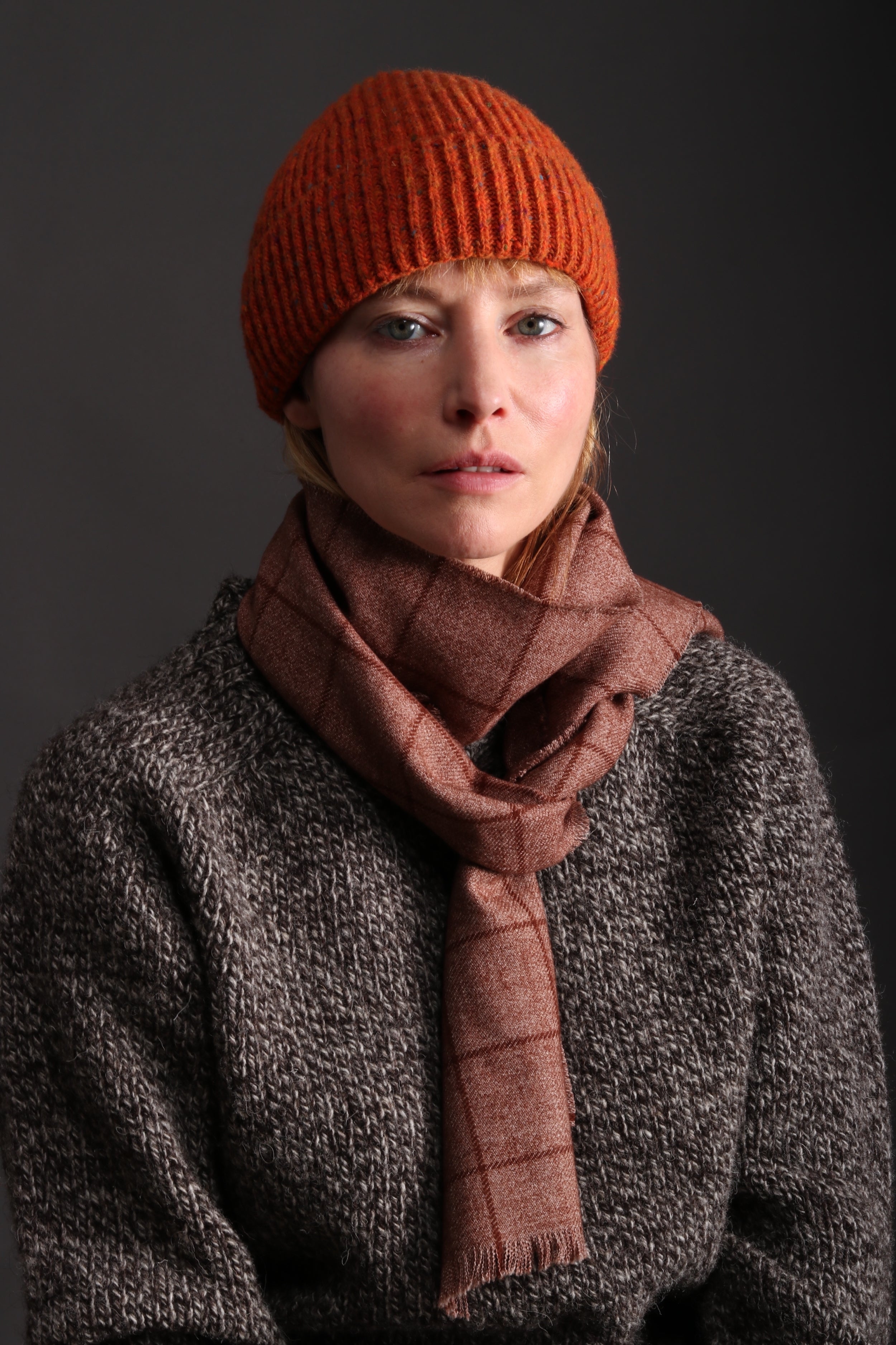 Woman wearing Tangerine Donegal Wool Hat with Heavy Heritage Lambswool Jumper and Checked Short Scarf