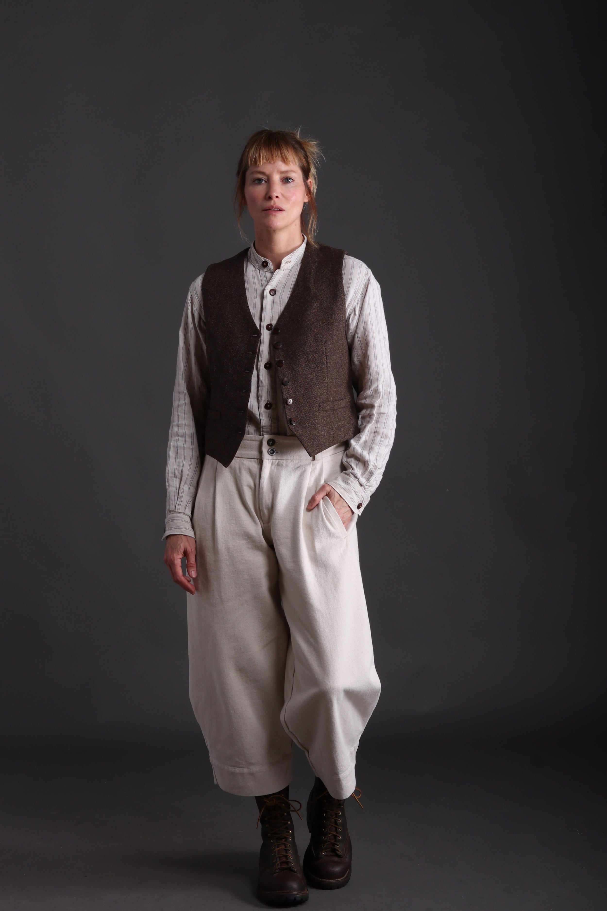 Woman wears Dutch Trouser in Seeded Denim with Linen Shirt and Women's Wool Waistcoat