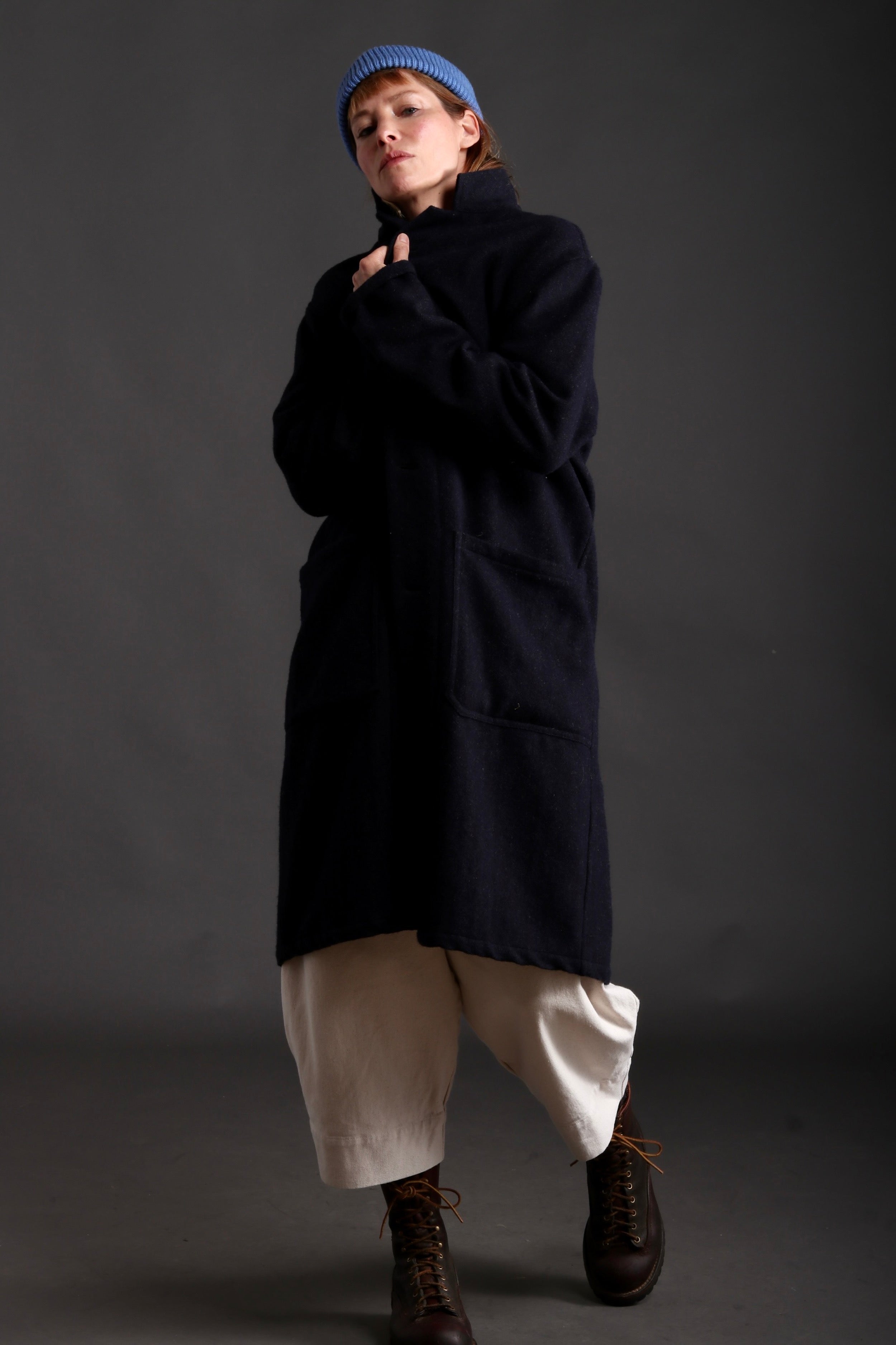 Sienna wears Carrier company Wool Coat in Navy with Collarless Work Shirt in Striped Linen, Dutch Trouser in Seeded Denim and Wool Hat in Sky