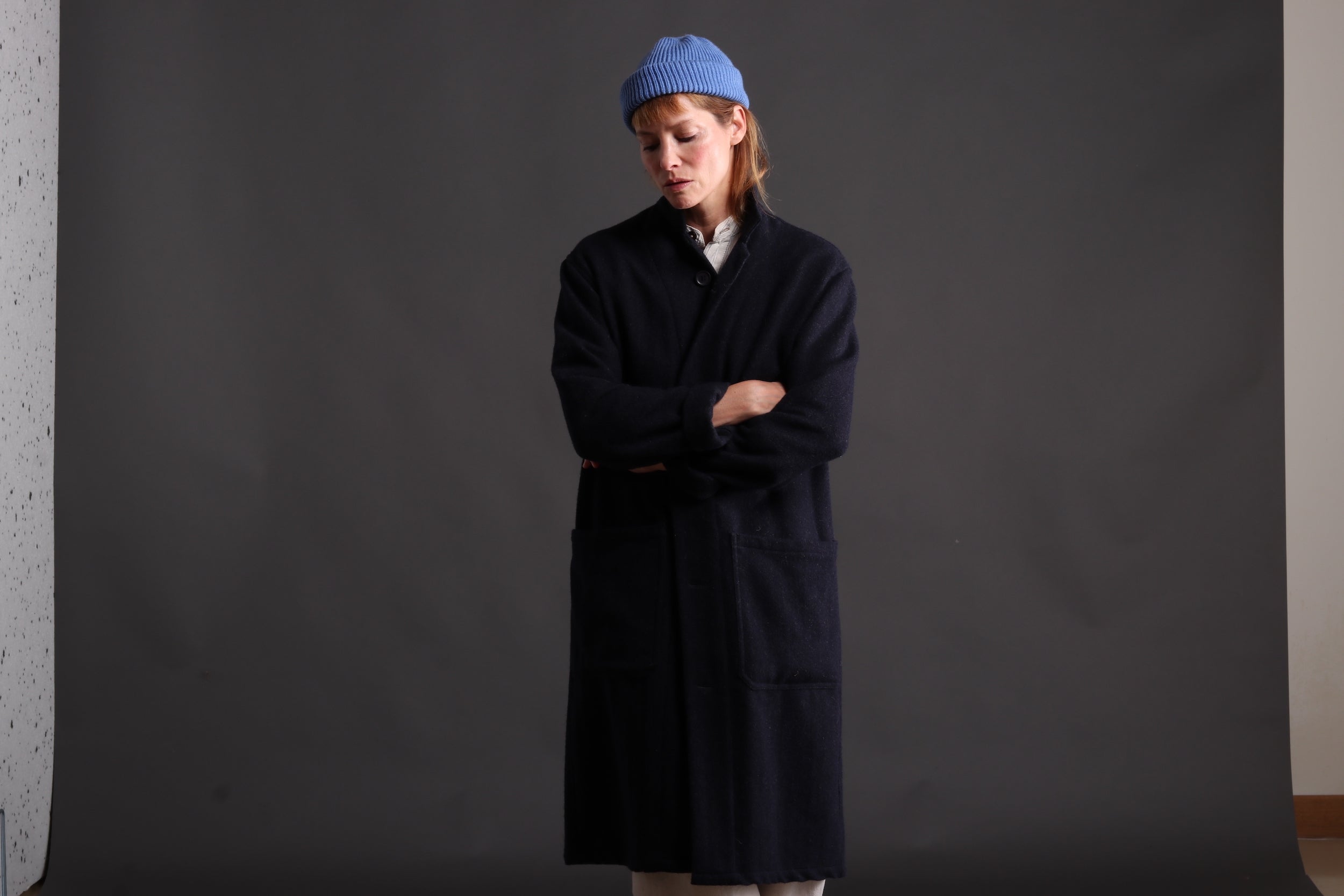 Sienna wears Carrier company Wool Coat in Navy with Collarless Work Shirt in Striped Linen, Dutch Trouser in Seeded Denim and Wool Hat in Sky