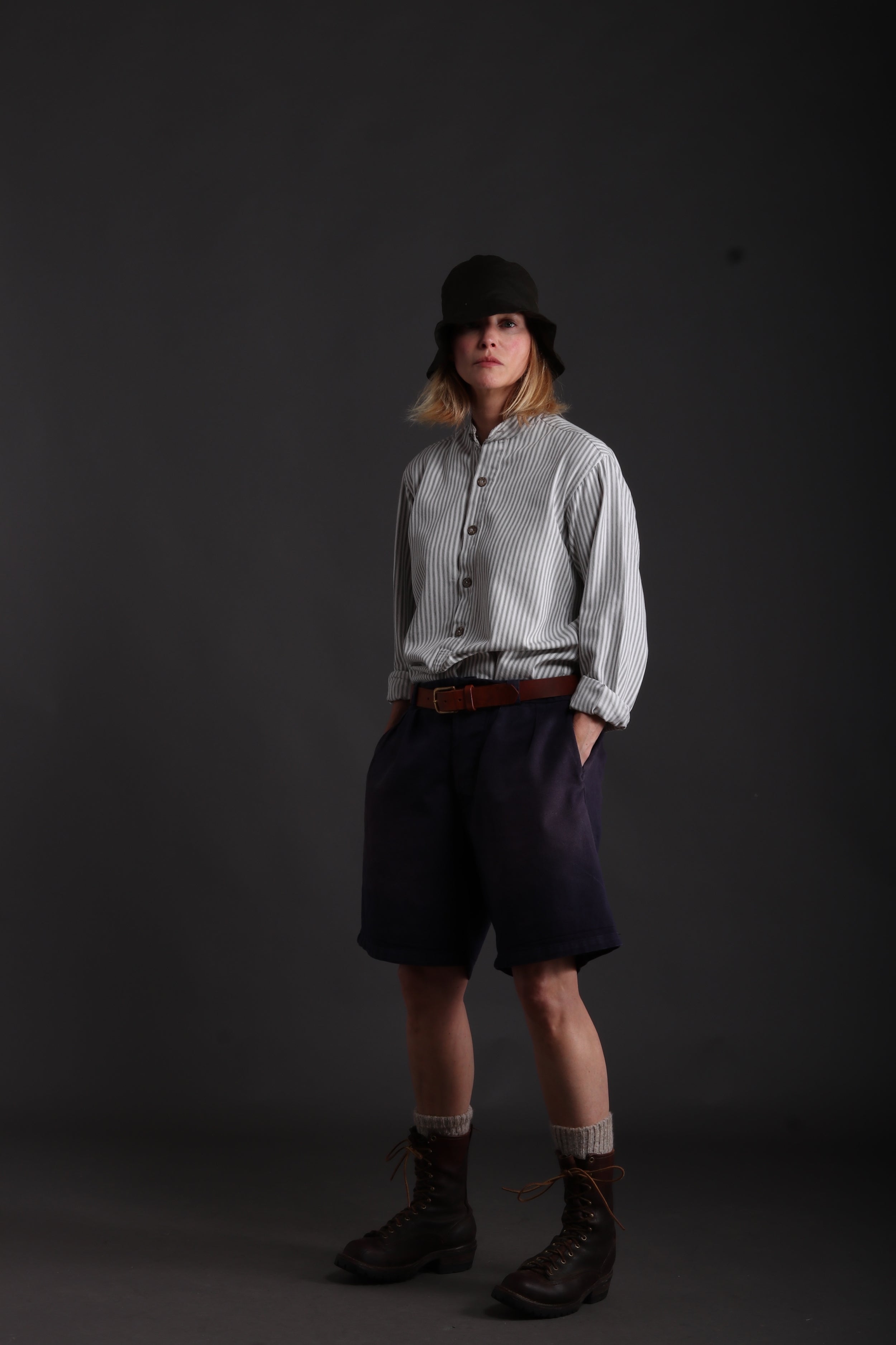 Woman wears Carrier Company Grandpa Shorts in Navy with Collarless Ticking Work Shirt