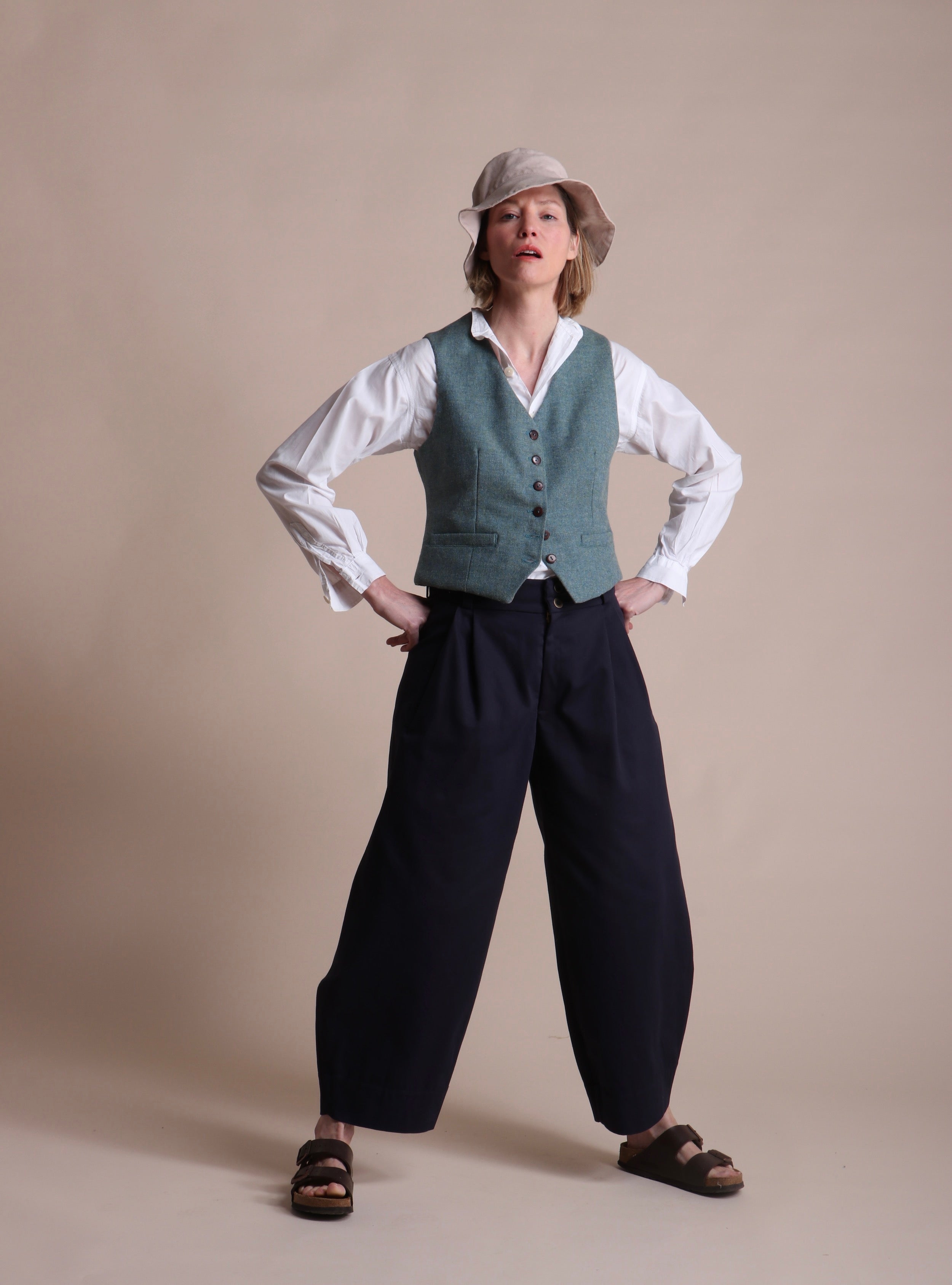 Woman wears Carrier Company Women's Wool Waistcoat in Marine with Lightweight Collarless Shirt and Dutch Trouser in Navy Cotton Drill