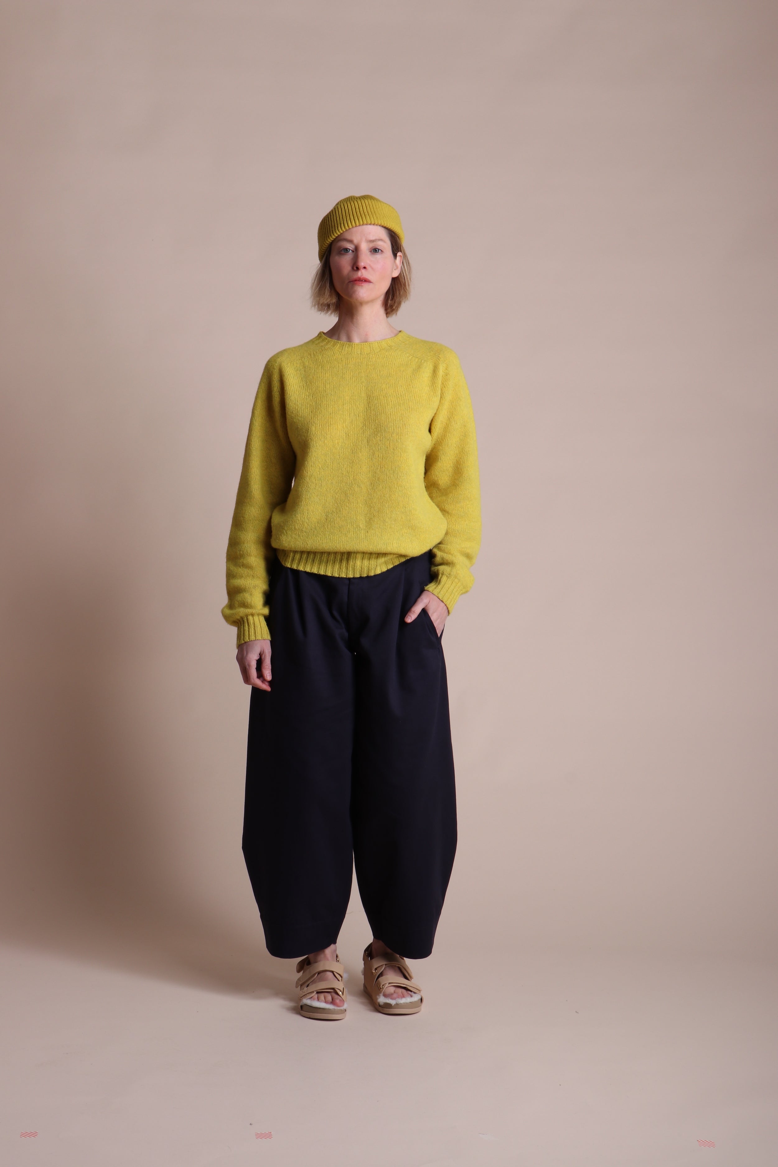 Woman wearing Carrier Company Wool Hat in Yellow with Shetland Lambswool Jumper and Dutch trouser