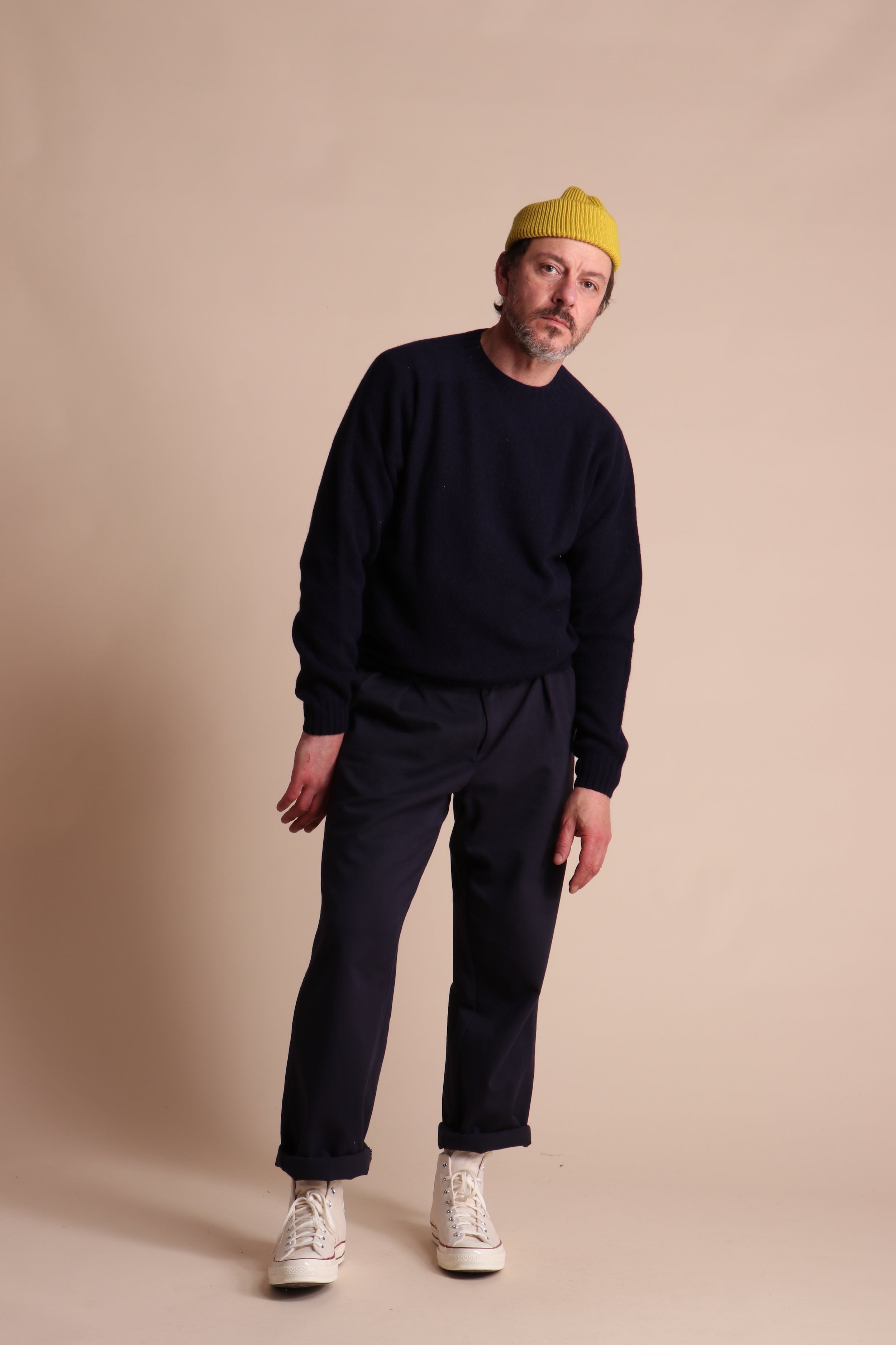 Man wearing Carrier Company Shetland Lambswool Jumper in Navy with Classic trouser and Wool Hat